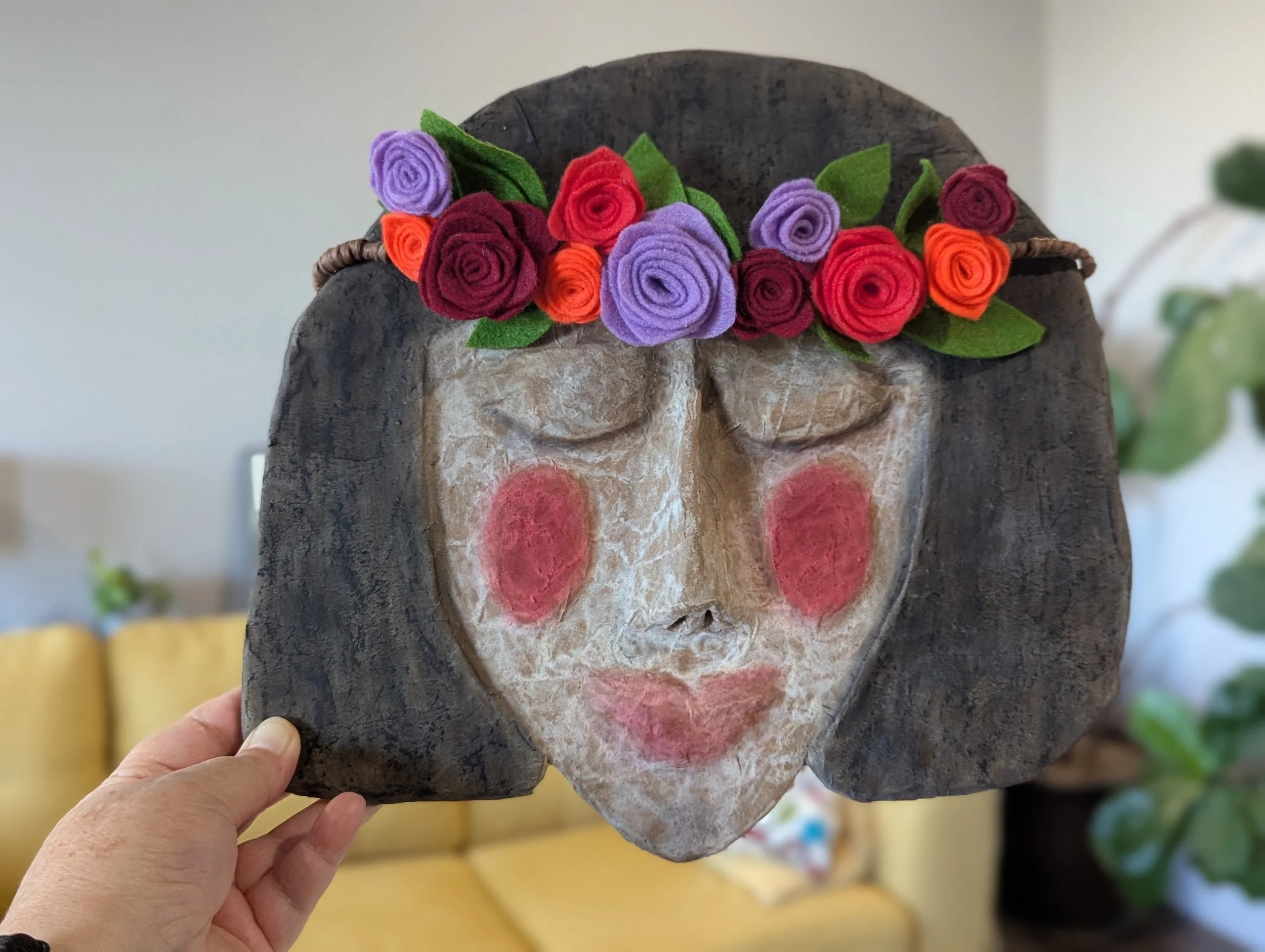 Handmade paper mâché spirit mask with felt flower crown, created for the Artful Crone intuitive creativity membership.