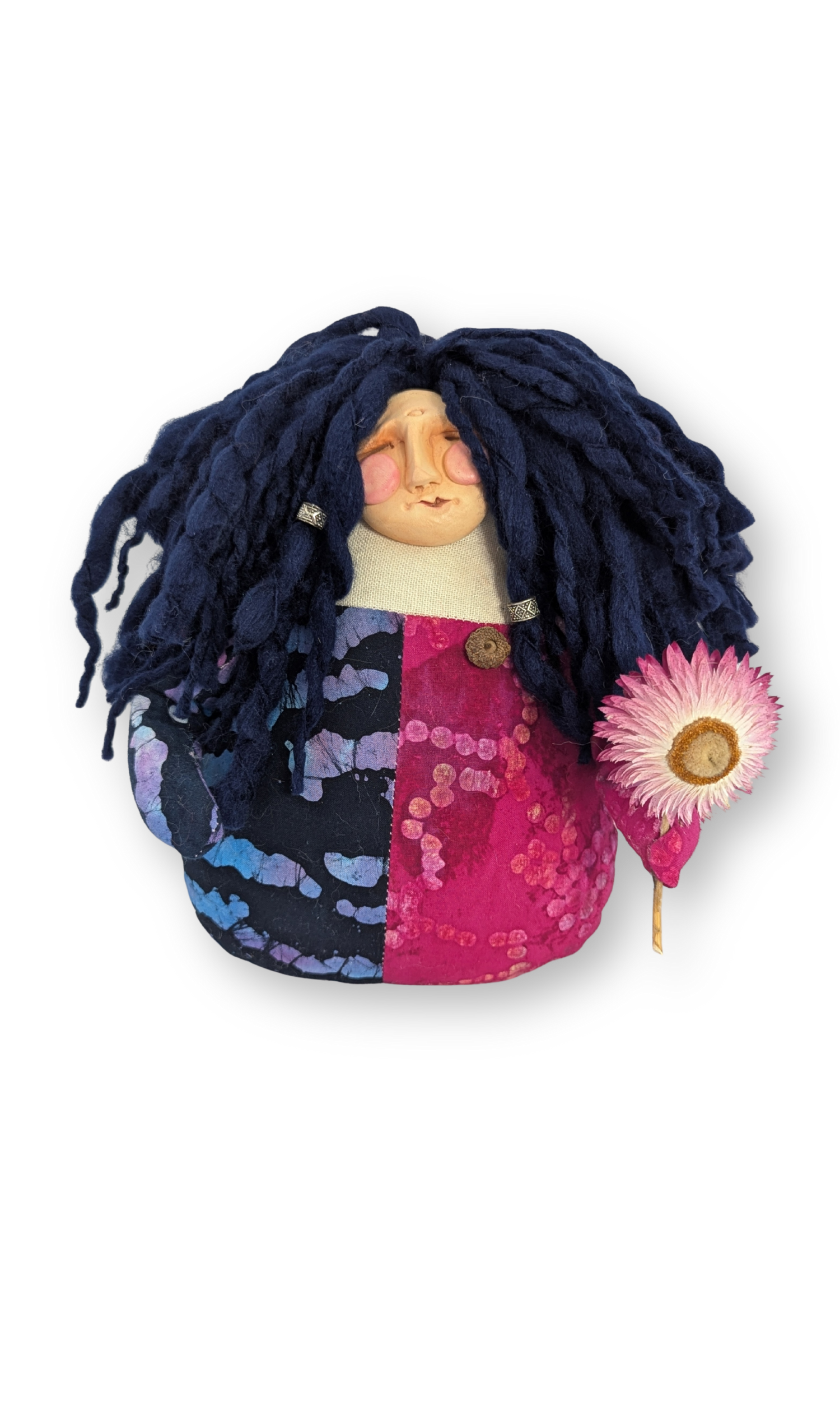 Front view of The Laughing Poppet, a handmade Guardian Doll with navy wool hair and a pink flower, created by Stacy Vajta.