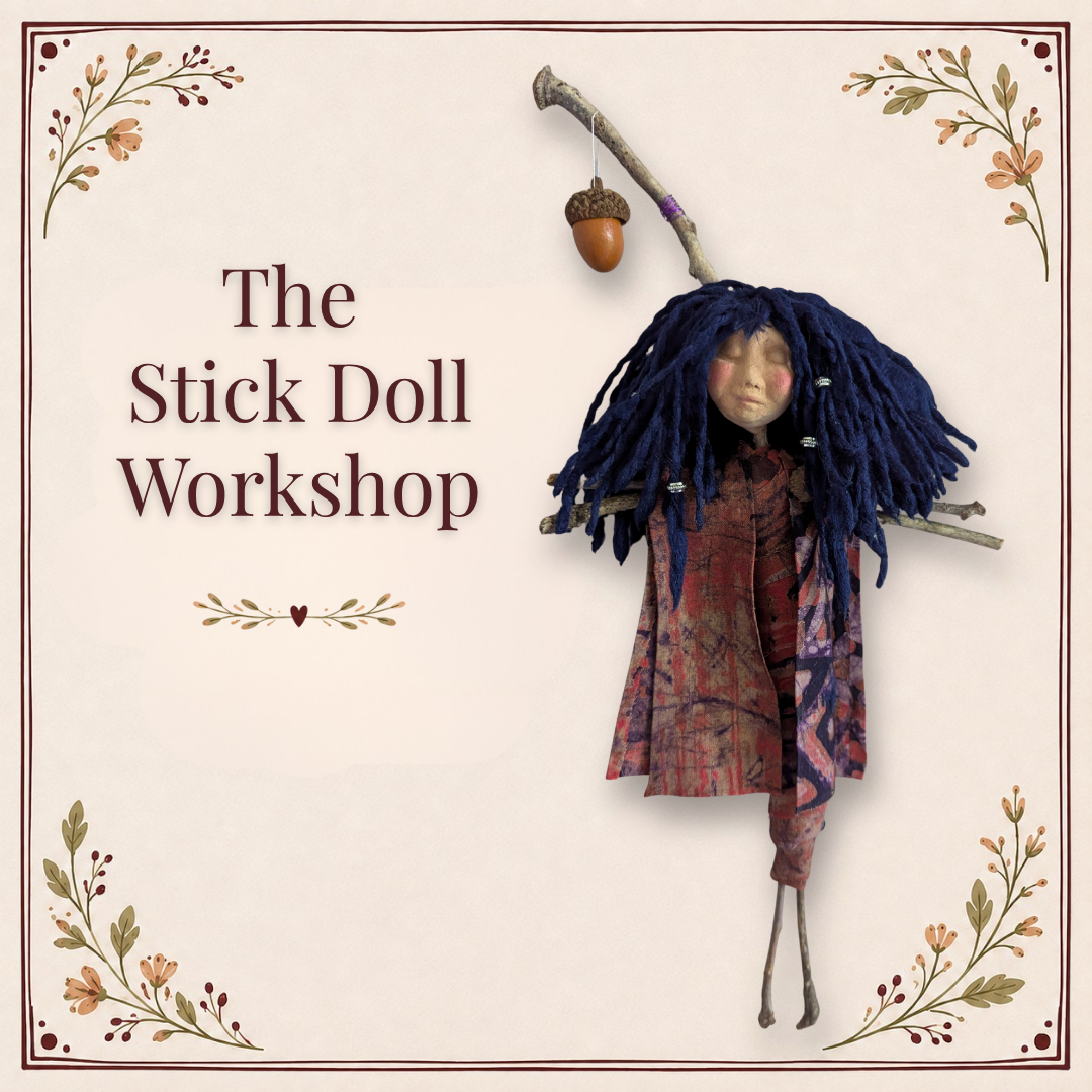 handmade stick doll with blue yarn hair and an acorn hanging from her sticks for the Asheville NC Stick Doll Workshop