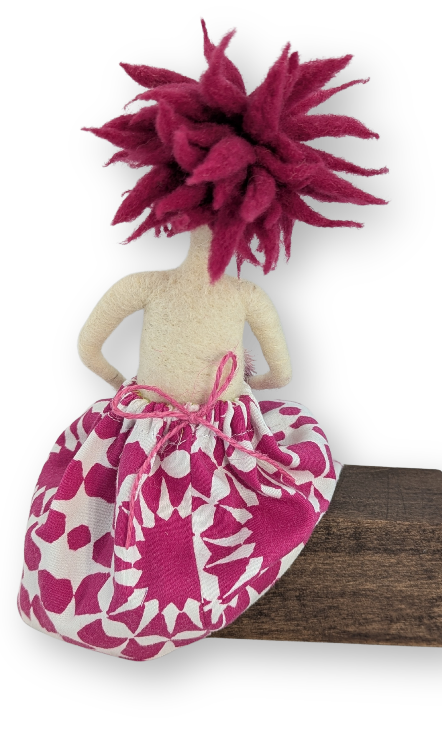 Back view of Flower Power Guardian Doll showing tied waistband, pink wool hair, and hand-sewn flower-patterned skirt.