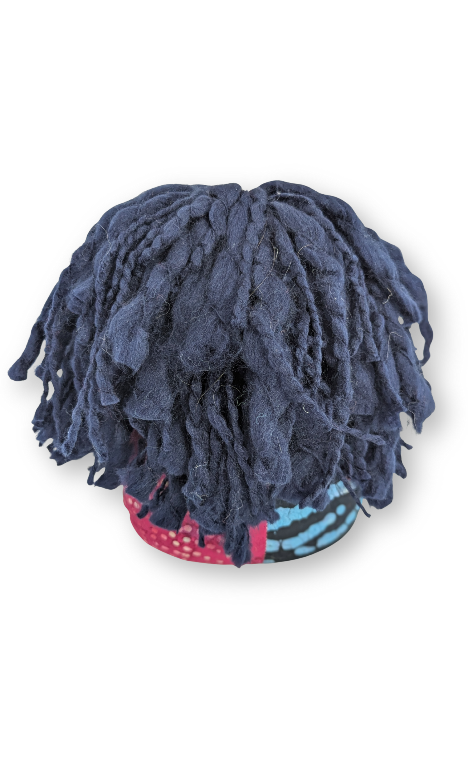 Back view of The Laughing Poppet doll highlighting her thick navy wool hair and handcrafted textile body.