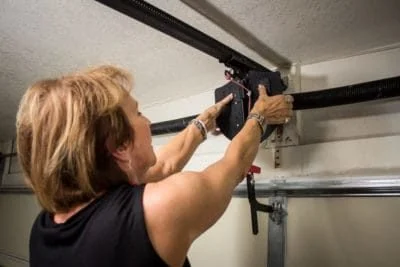 Garage Shield installing in garage by older women made easy-e1597852317652.jpg