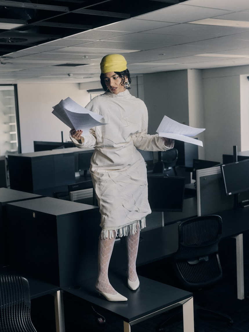 Roxie wears Strateas Carlucci coat, LEAIR hat, Bassike shoes, stylist's own stockings, Louise Olsen earrings.