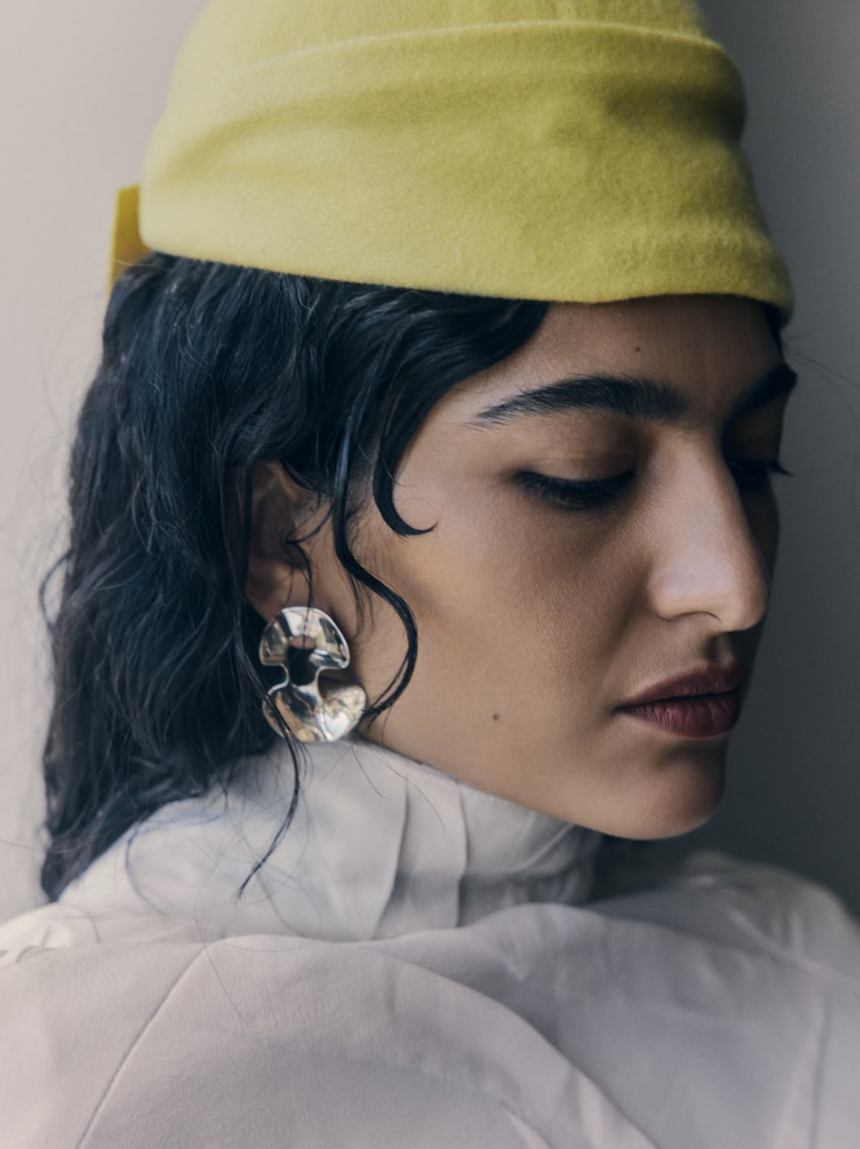 Roxie wears Strateas Carlucci coat, LEAIR hat, Louise Olsen earrings.