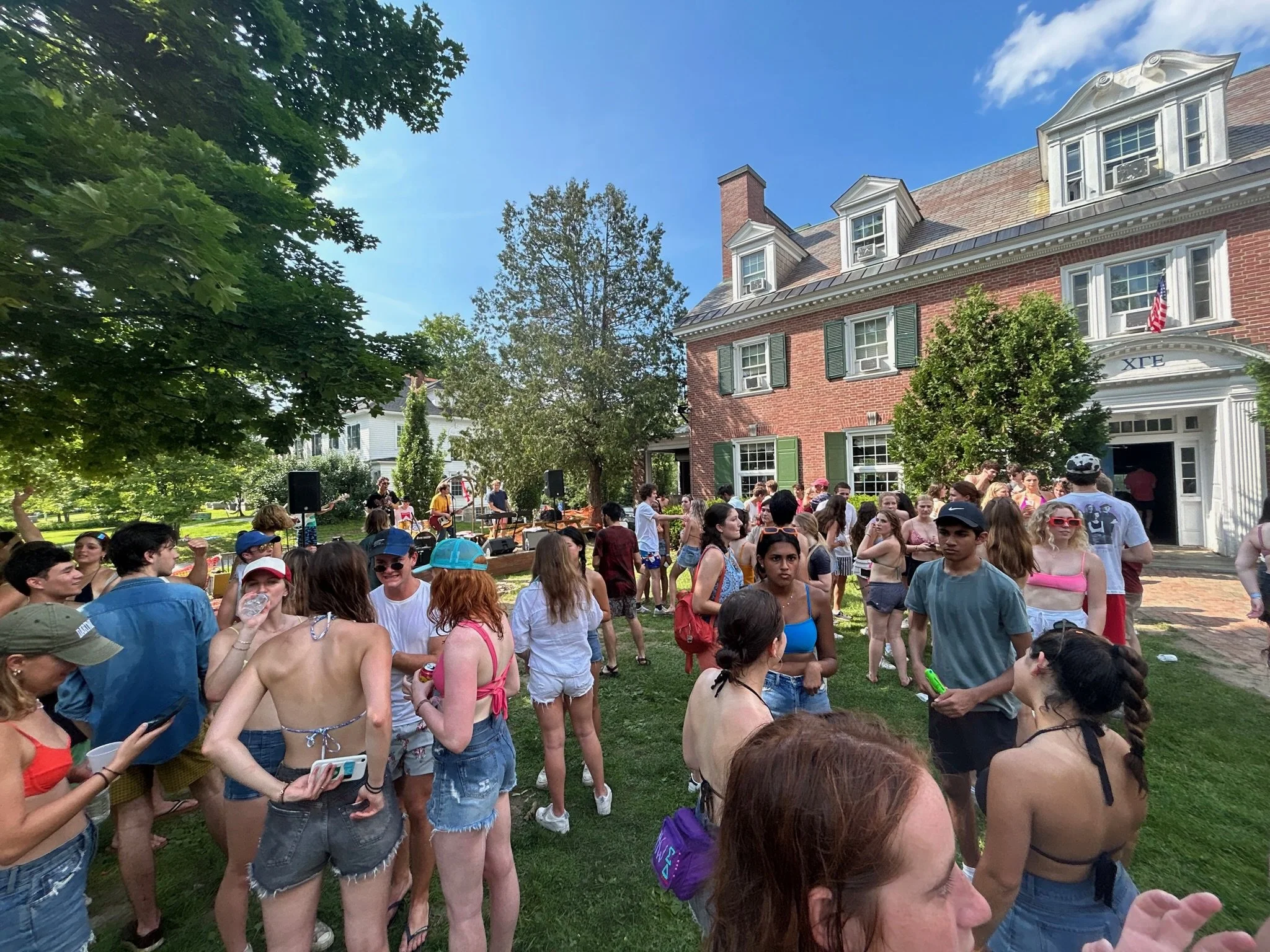 Outdoor party with people socializing near brick building