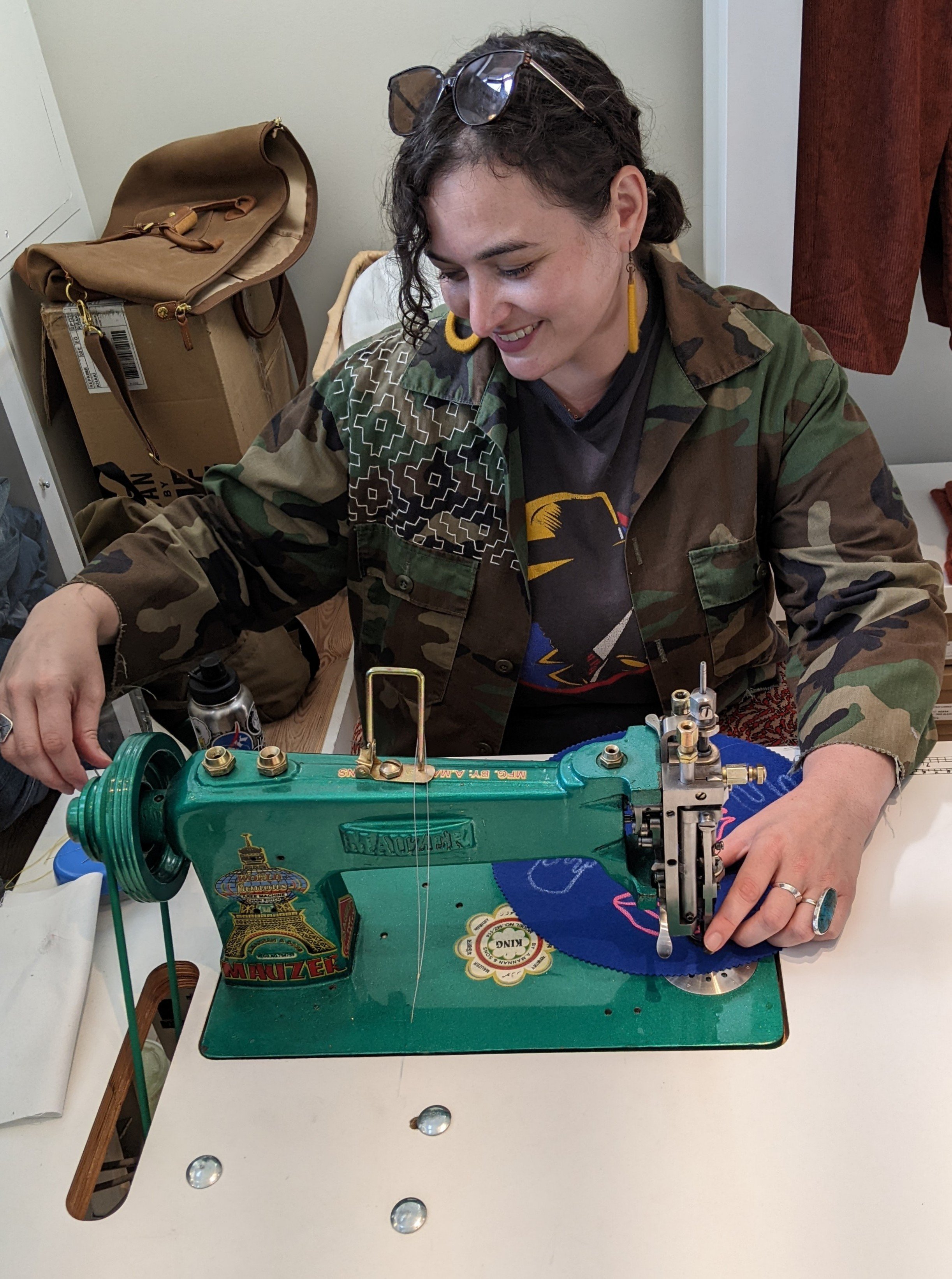 Rae Miller in her studio at a sewing machine.