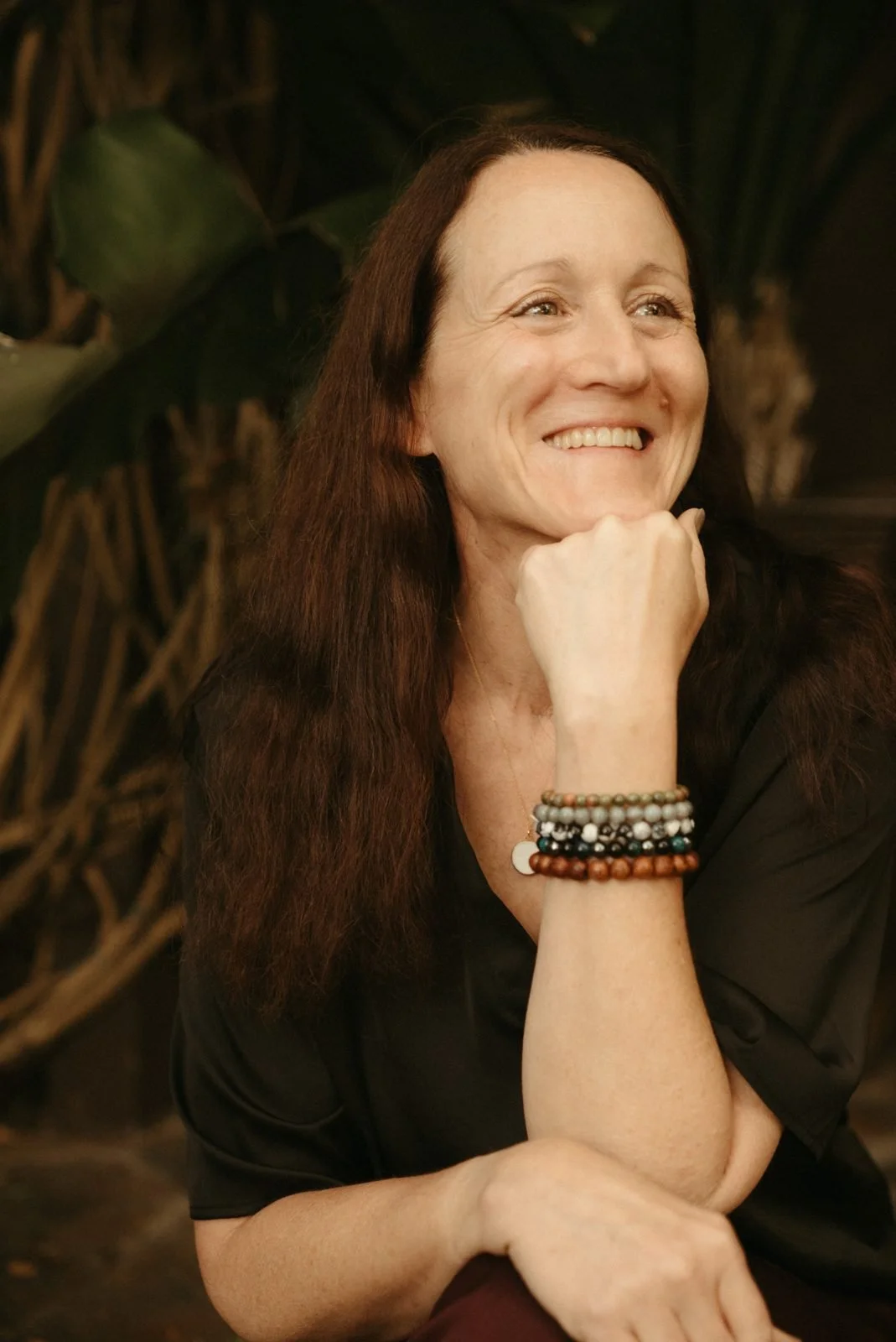 Joy Kelleher, smiling, chin resting on her hand