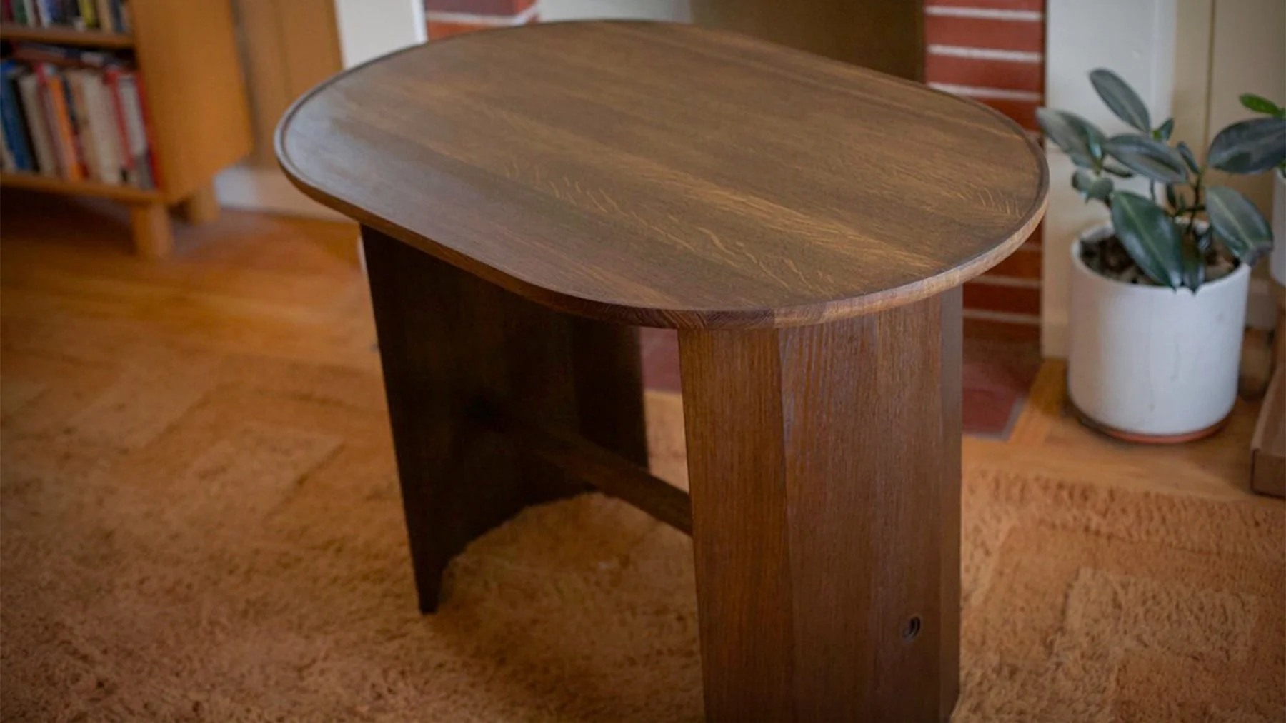 Elongated cocktail table. This was a fun bit of custom work.

The finish is classic craftsman - ammonia fumed white oak and black wax, but the form is modern with a scooped table top, coopered base, and an art deco inspired through tenon. 

My though