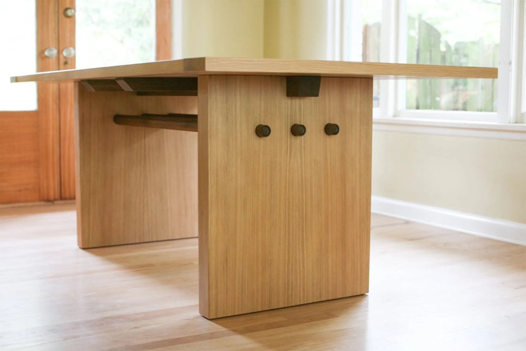 Big oak table delivered to Seattle. The table is designed to mirror southwestern architecture, but looks lovely in any space. 

The support structure is a combination of fumed and natural white oak. The grain is meticulously chosen to be harmonious f