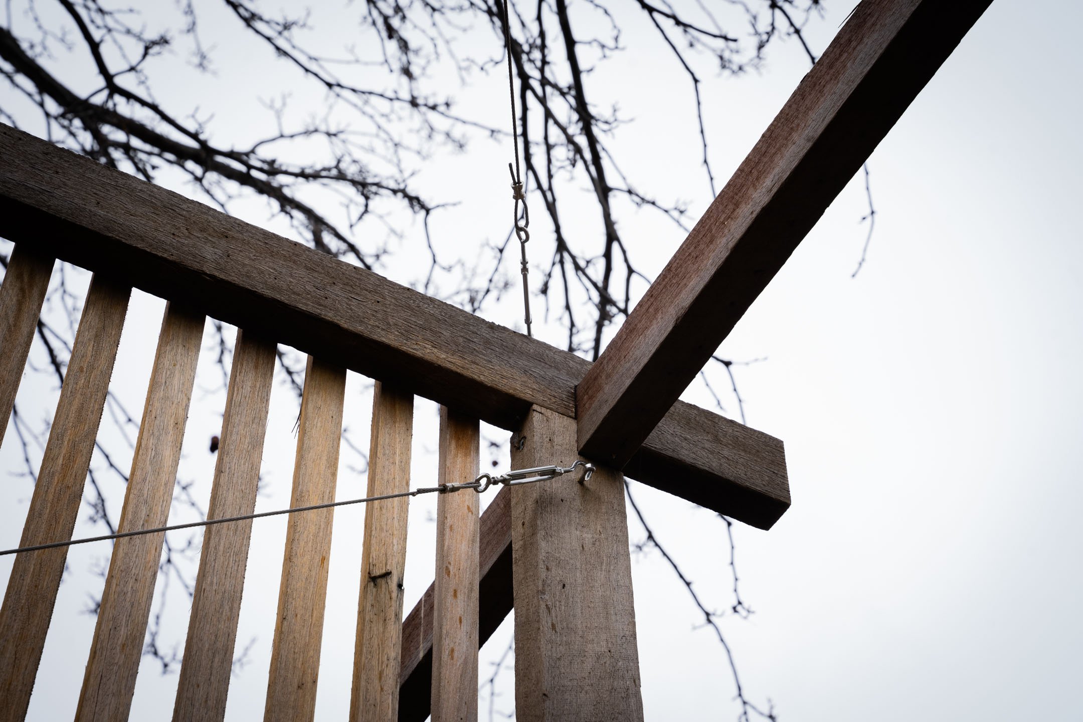 A joinery detail from the outdoor meeting room installed by myself and my good friend Joel Douglas from Wooden.
Tensioned steel cables installed in X formation brace the structure preventing it from rocking. Manchurian pears are seen in the backgroun