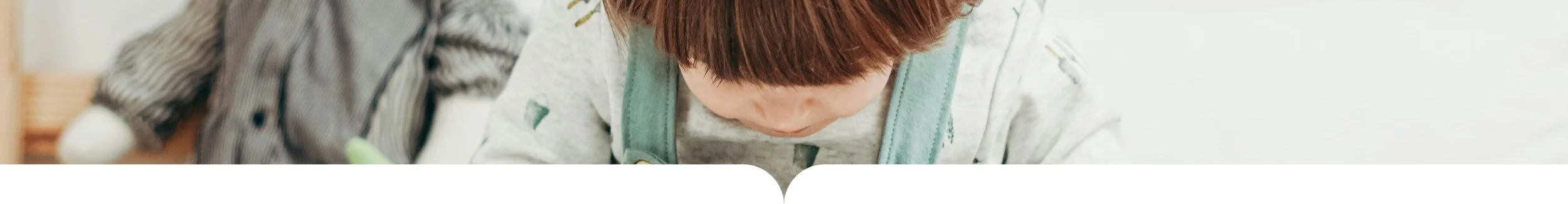Child looking down while playing