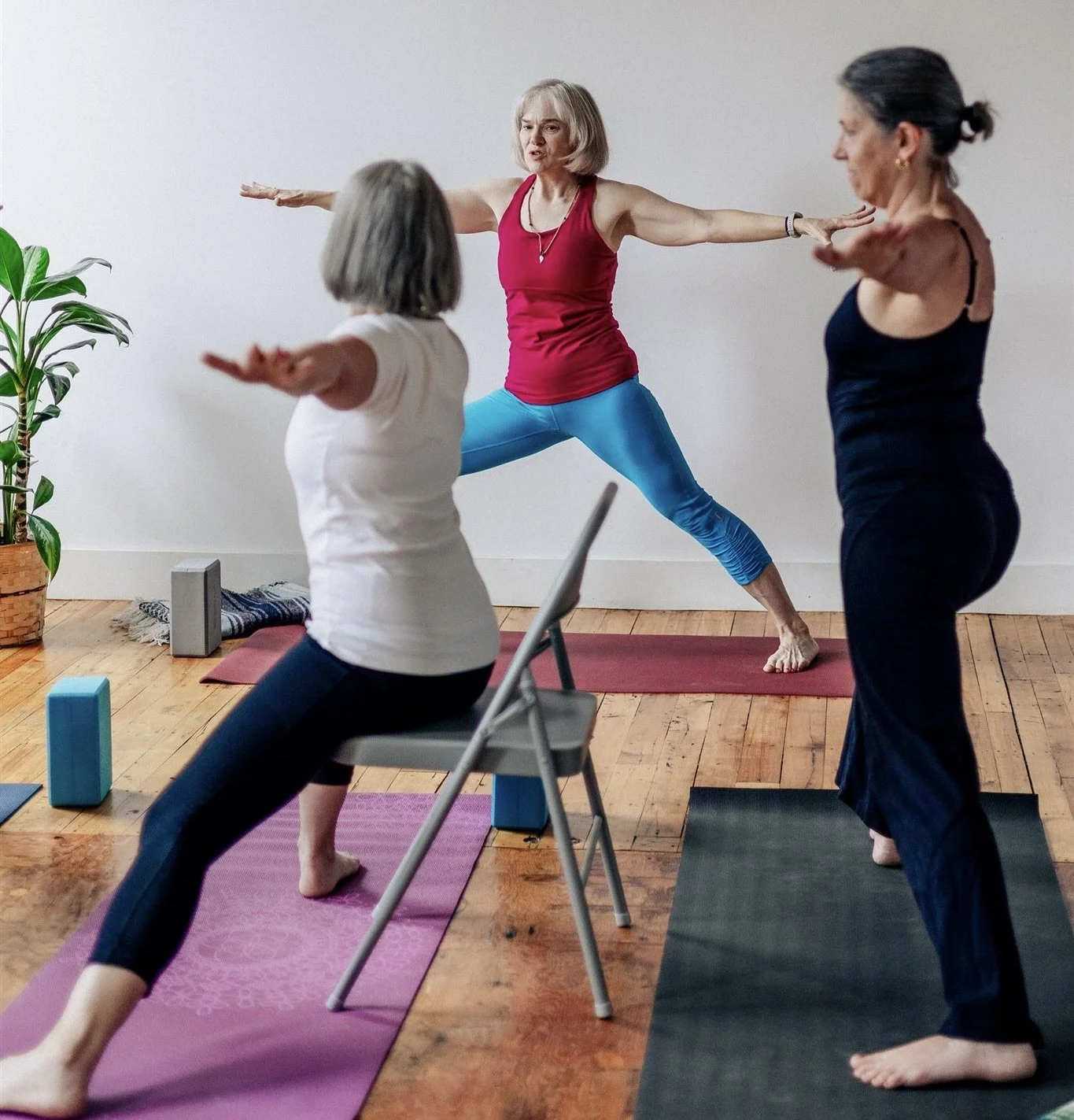 Group of ladies praciting yoga postures with breathing to help manage stress and improve sleep