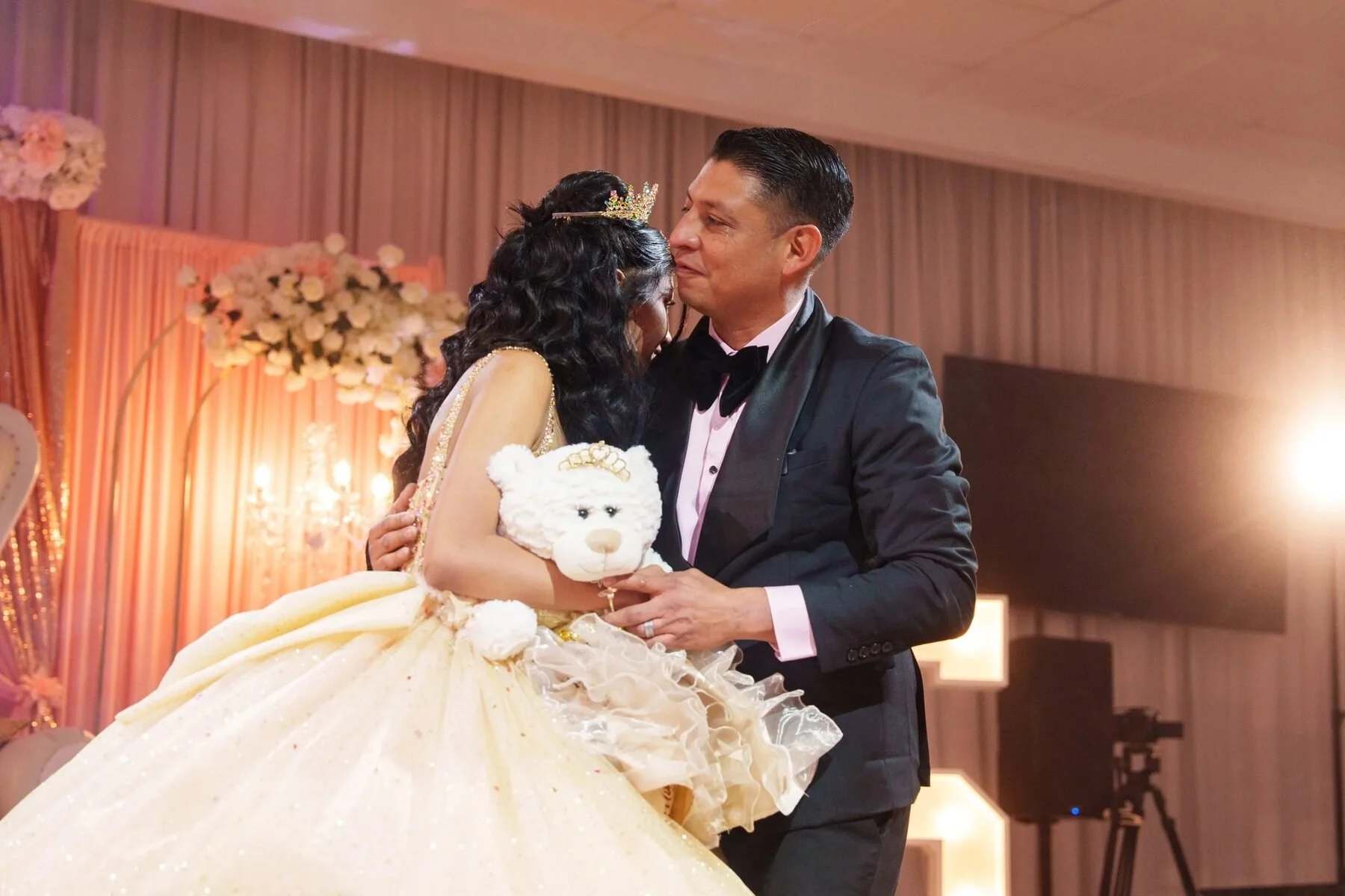 Father shares the last doll tradition with his daughter at a Texas quinceanera.