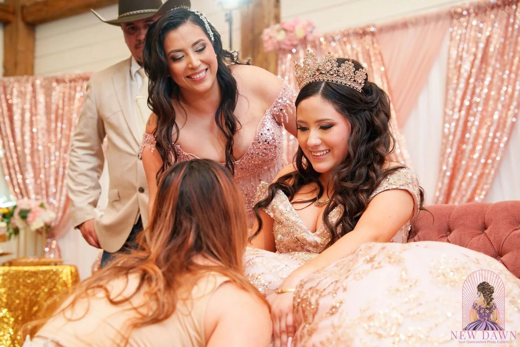 Family helps a quinceanera with her rose-gold gown before her Dallas celebration.