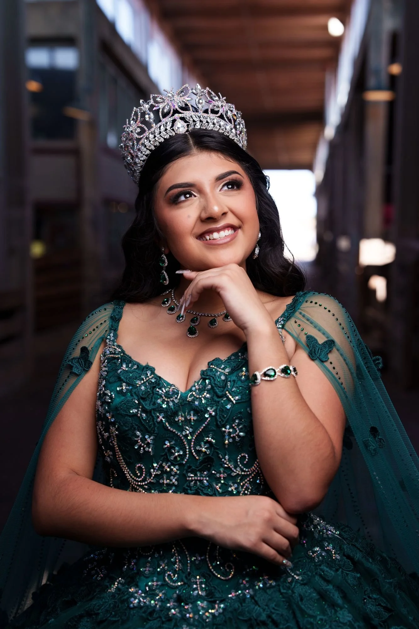Close formal portrait of Nevaeh with her silver tiara, emerald necklace, and butterfly cape at Fort Worth Stockyards