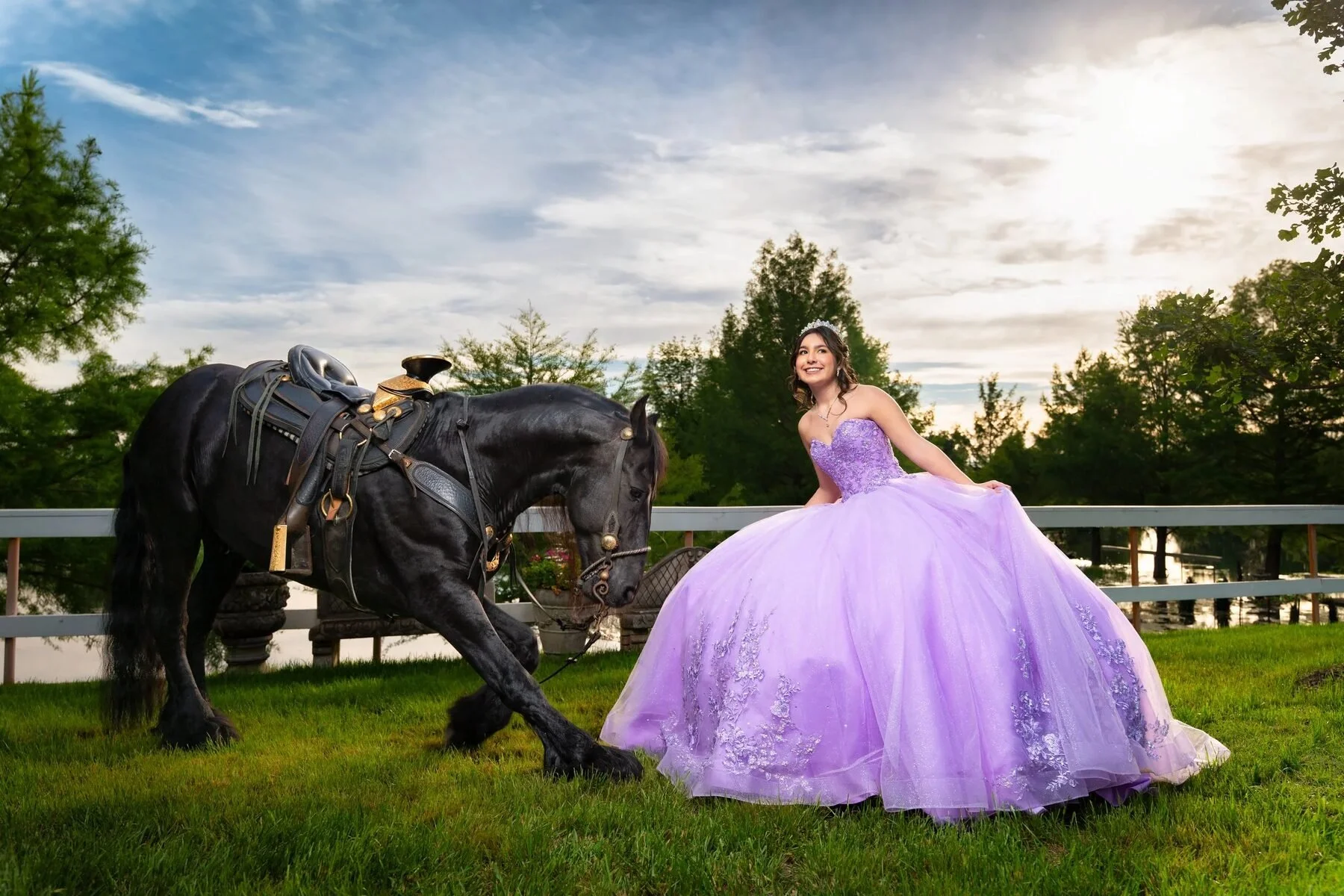 Quinceañera in a lilac gown beside a black horse at a Texas ranch at sunset