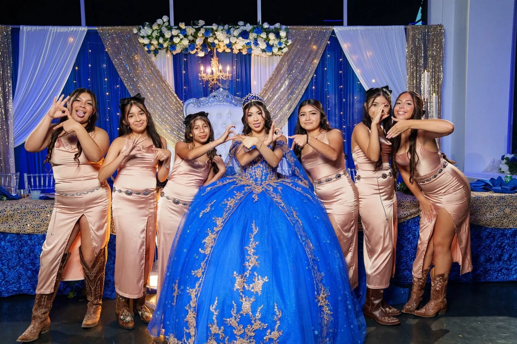 Quinceañera in a blue gown with her court of honor at a Dallas reception