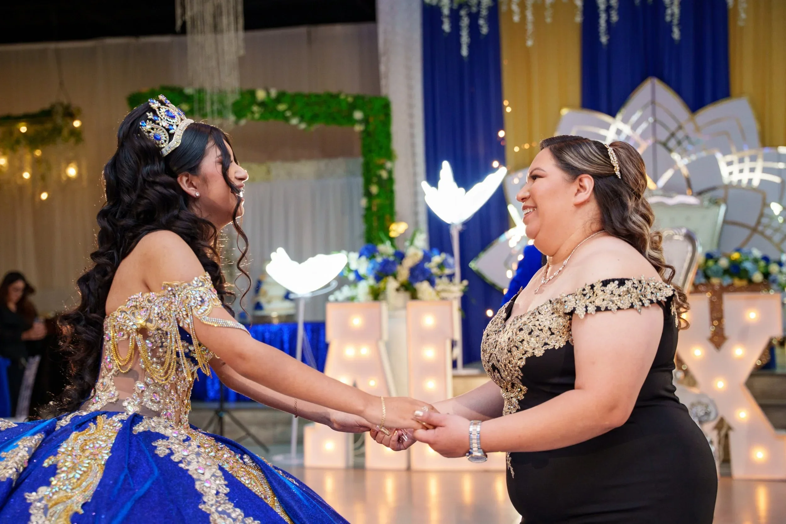 Mother and daughter share an emotional dance in a royal blue gown at a Dallas–Fort Worth quinceañera