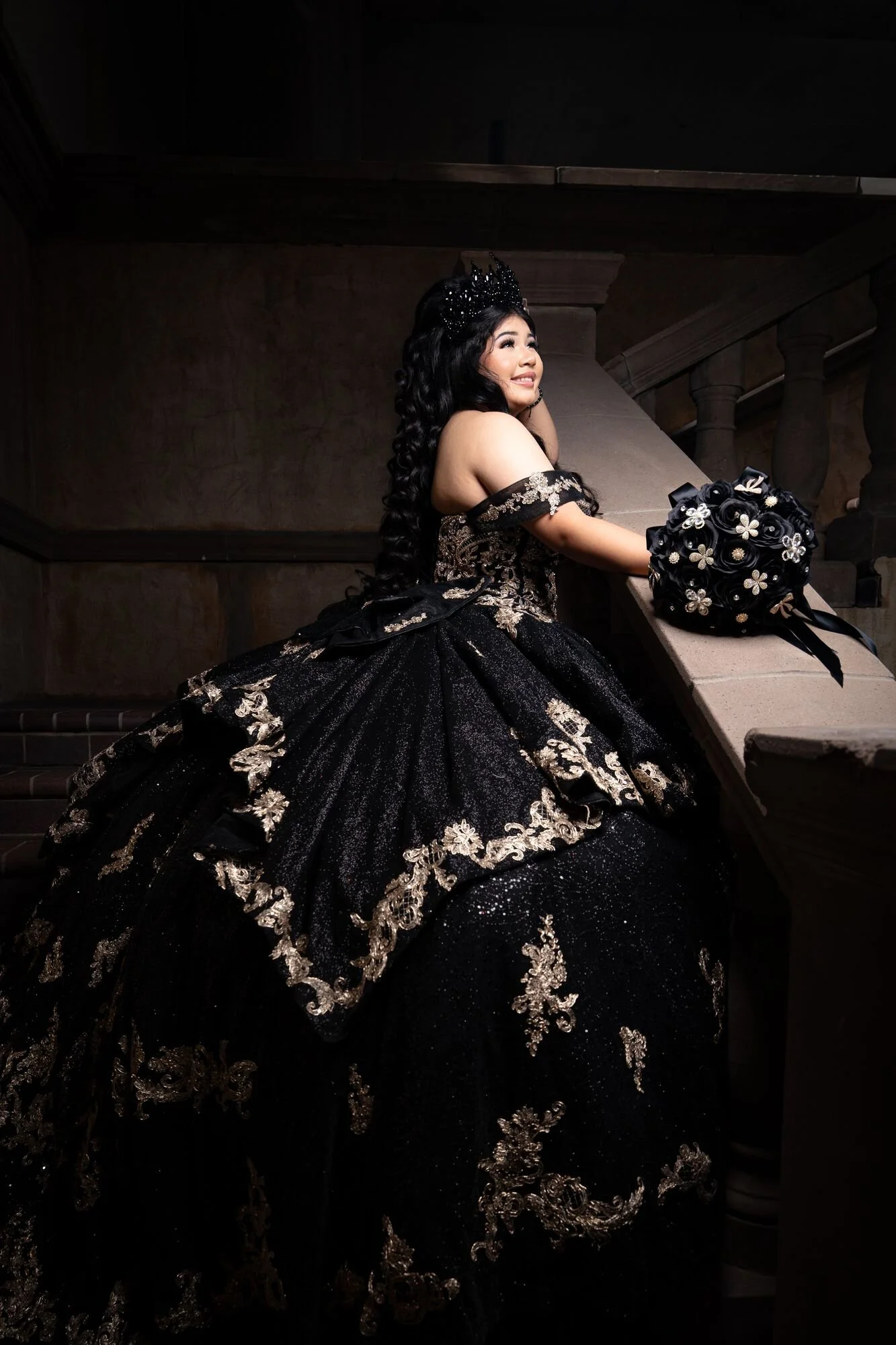 Black and gold quinceañera ballgown on grand staircase at Mandalay Canal Las Colinas DFW preshoot