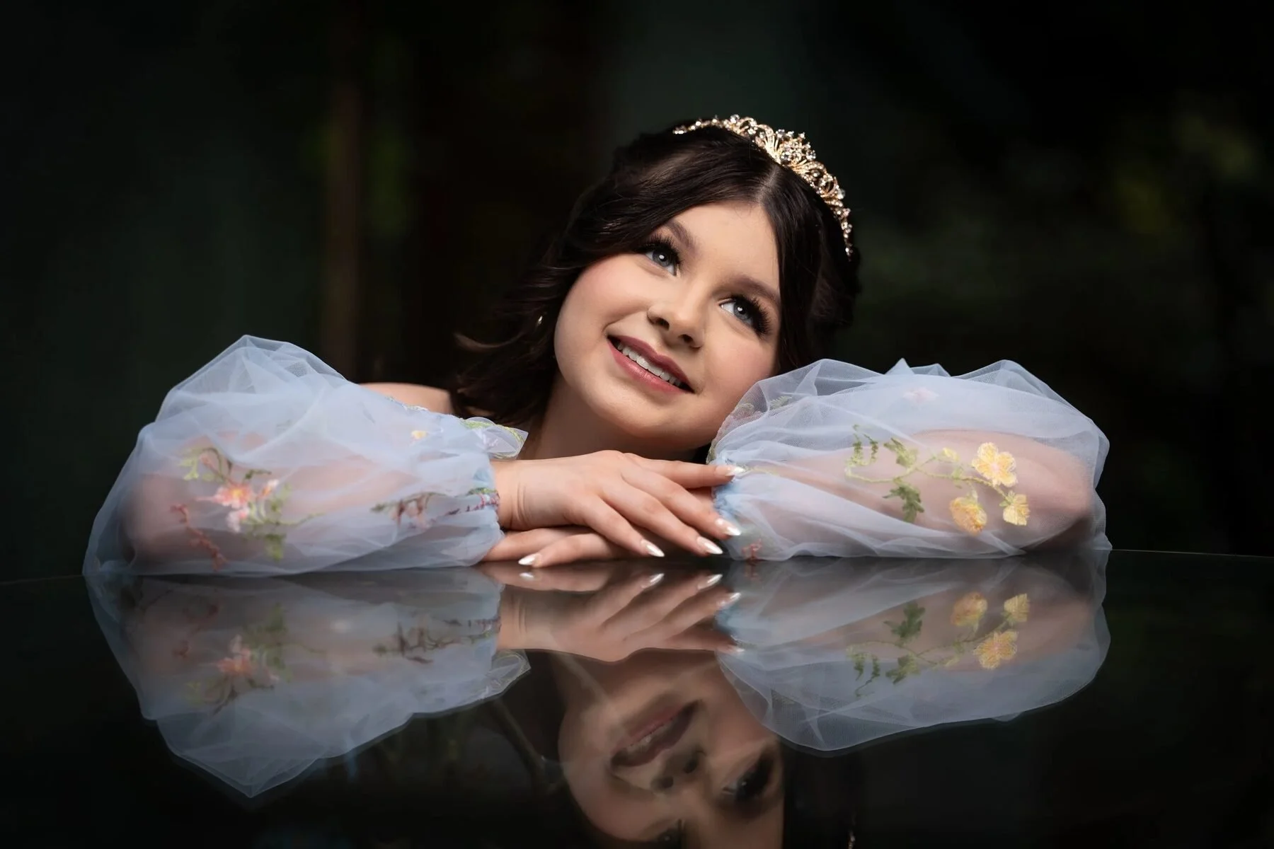  KBQuinceanera in a blue floral gown poses with a mirror reflection for a DFW Save the Date session.