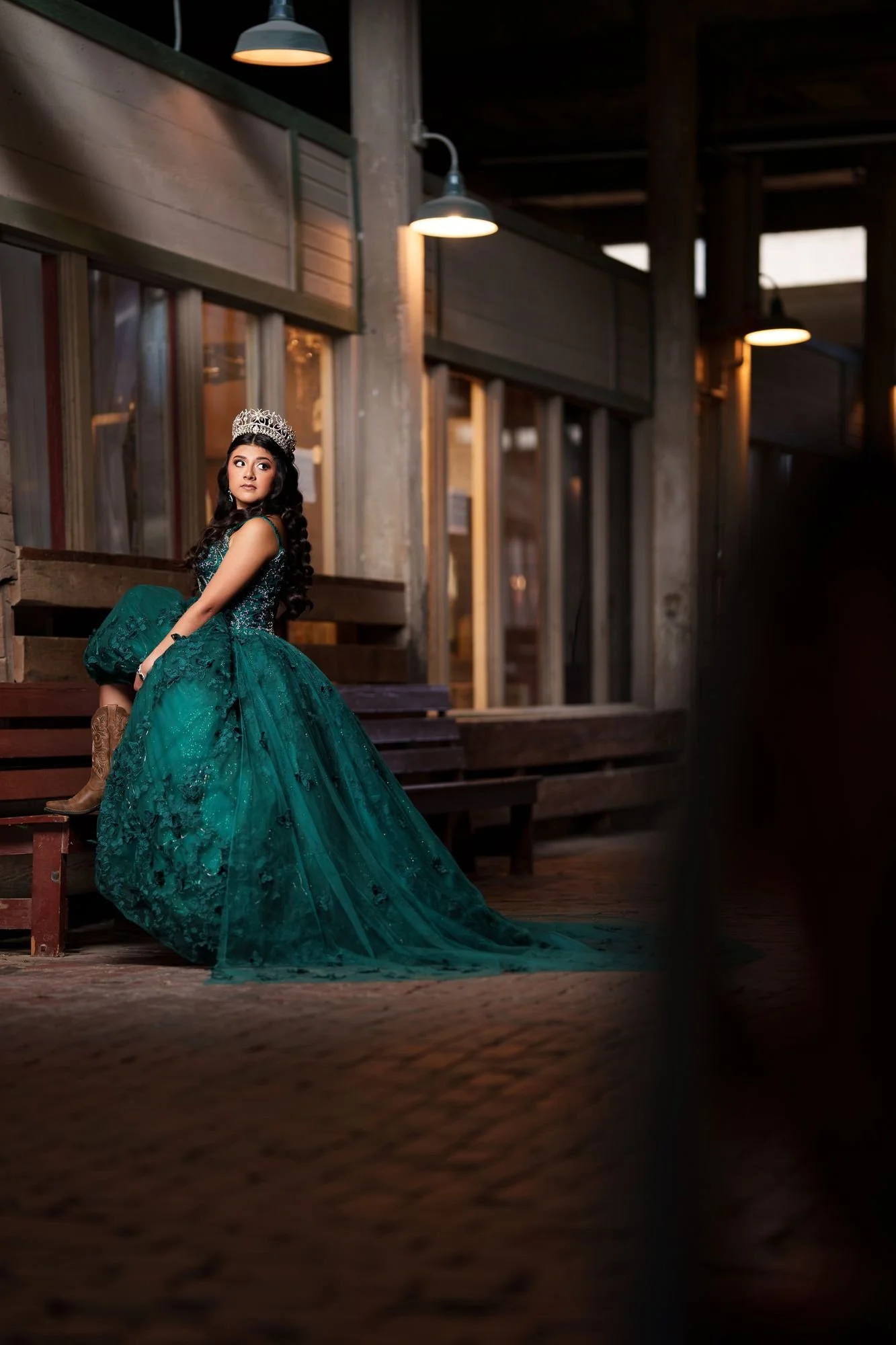 Nevaeh's emerald gown against painted wood walls at Fort Worth Stockyards