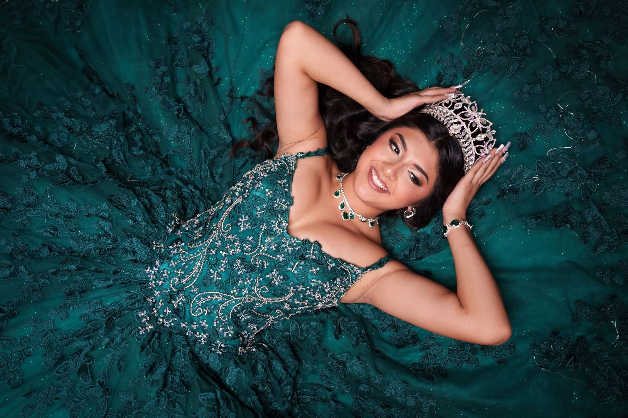 Editorial overhead portrait of Nevaeh in her emerald quinceañera ballgown with matching emerald jewelry and silver tiara at Fort Worth Stockyards