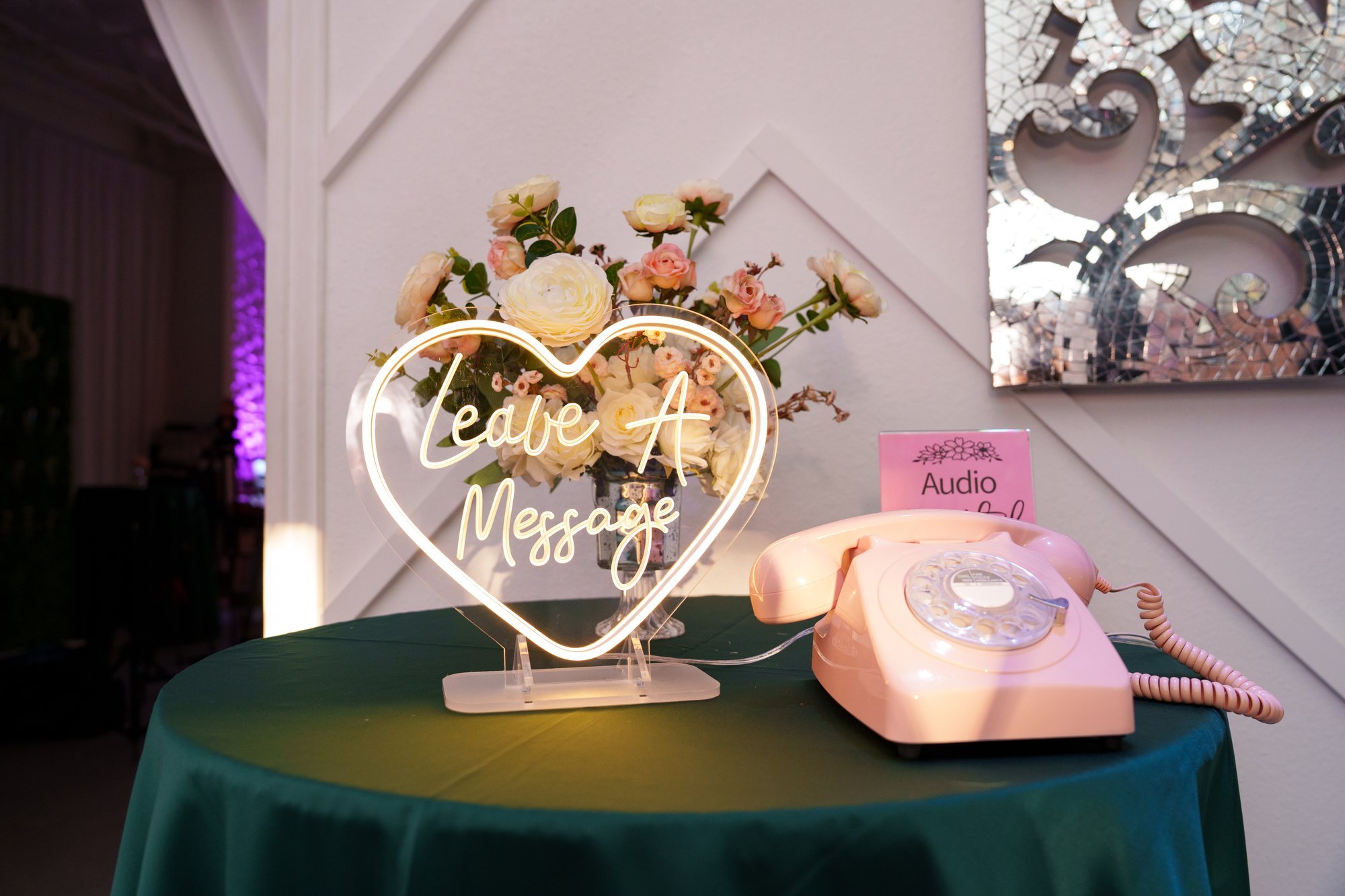 Guest message station with a vintage pink rotary phone and 'Leave a Message' sign at Nevaeh's quinceañera