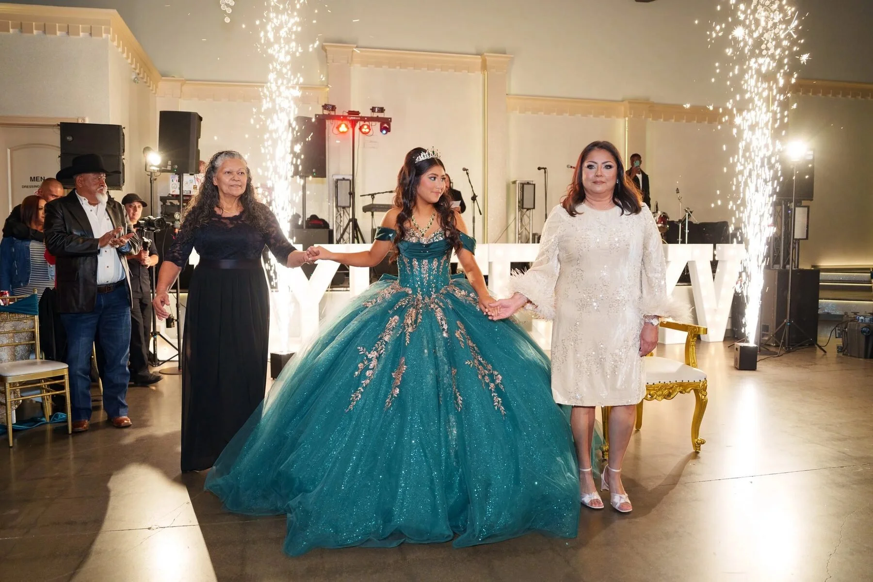 Quinceañera in an emerald gown making a grand entrance with sparklers at a DFW venue