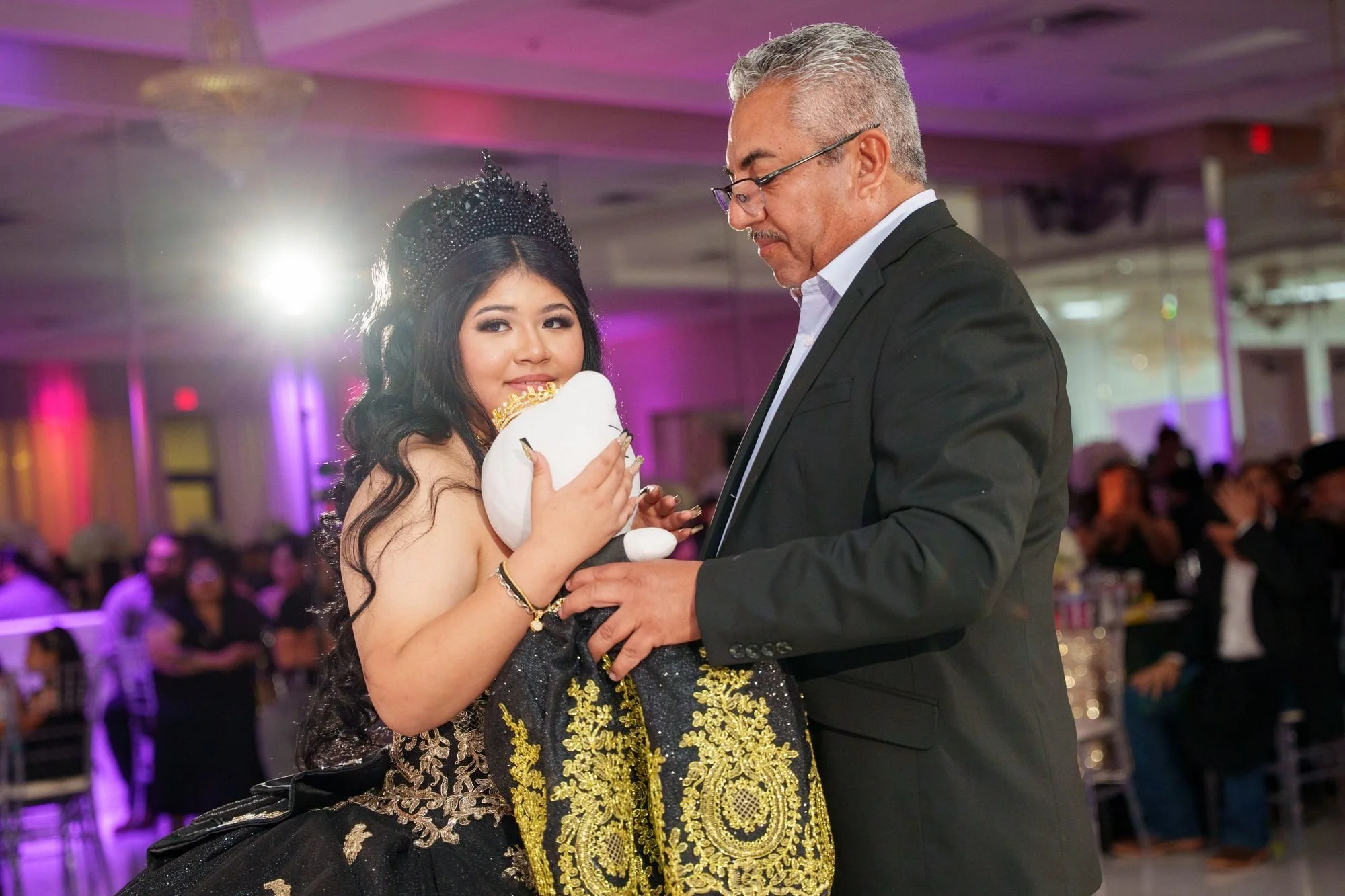 Jayden in black and gold quinceañera ballgown waltzing with her grandfather in a black Stetson and Western jacket on the marble dance floor at Luxor Banquet Hall Carrollton TX