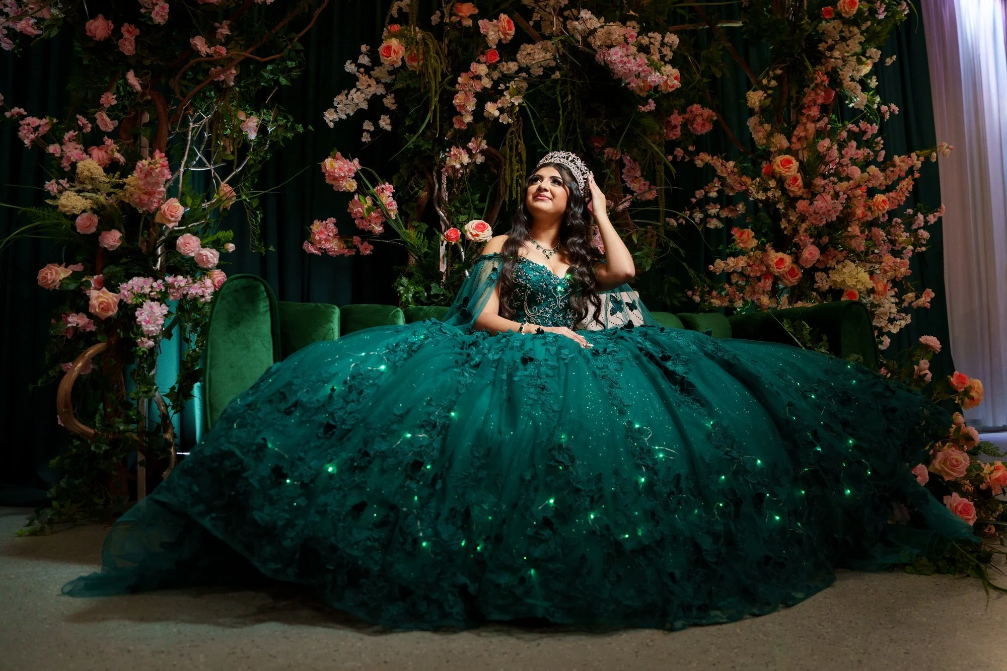 Nevaeh in emerald quinceañera ballgown with crown and tiara at Blanc Event Center Dallas