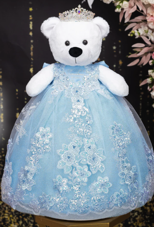 Quinceañera last doll dressed in a light blue gown with lace embroidery and a small crown