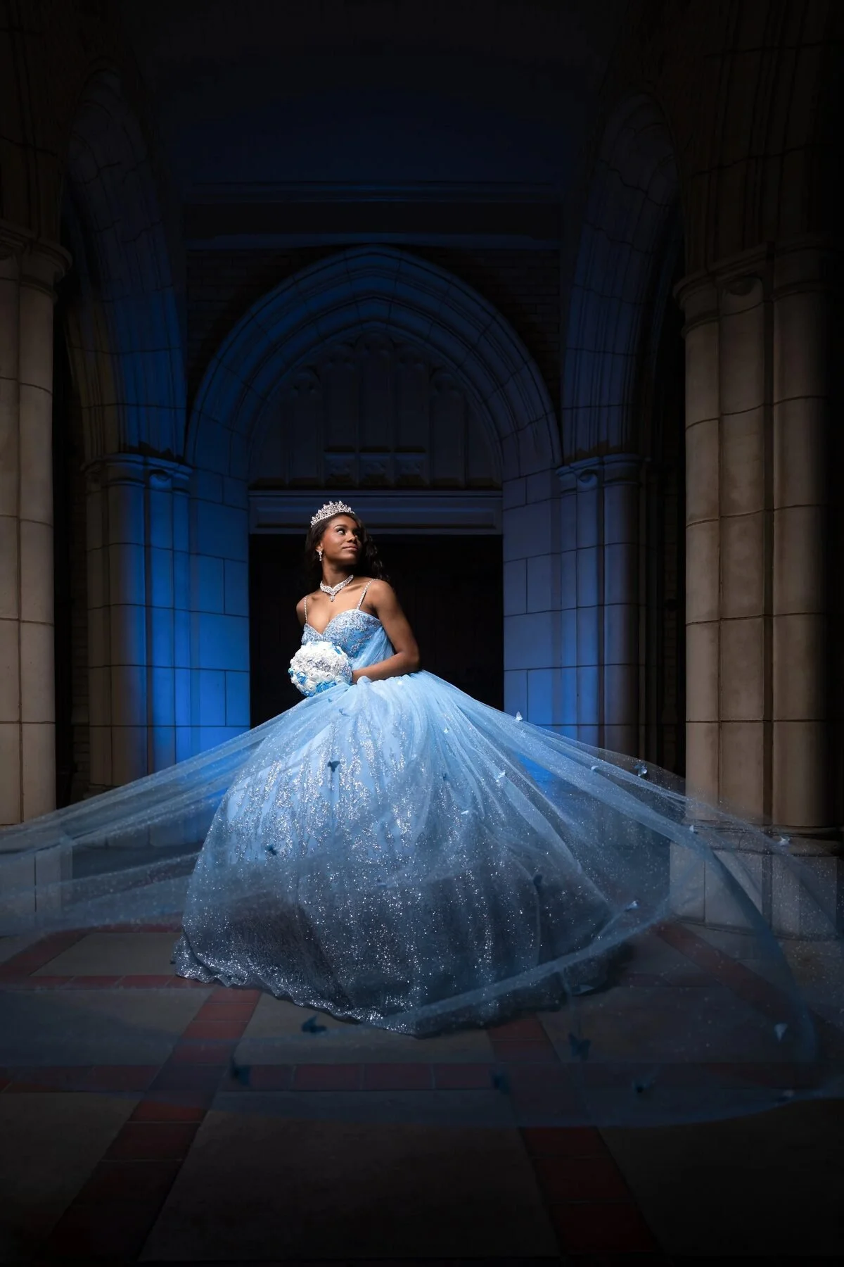 Quinceañera in a light blue Cinderella gown with a flowing train at a Dallas cathedral