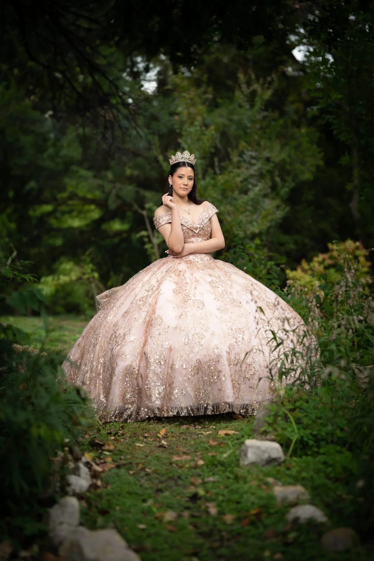 Quinceañera in a rose-gold sequined ball gown in a lush Dallas garden