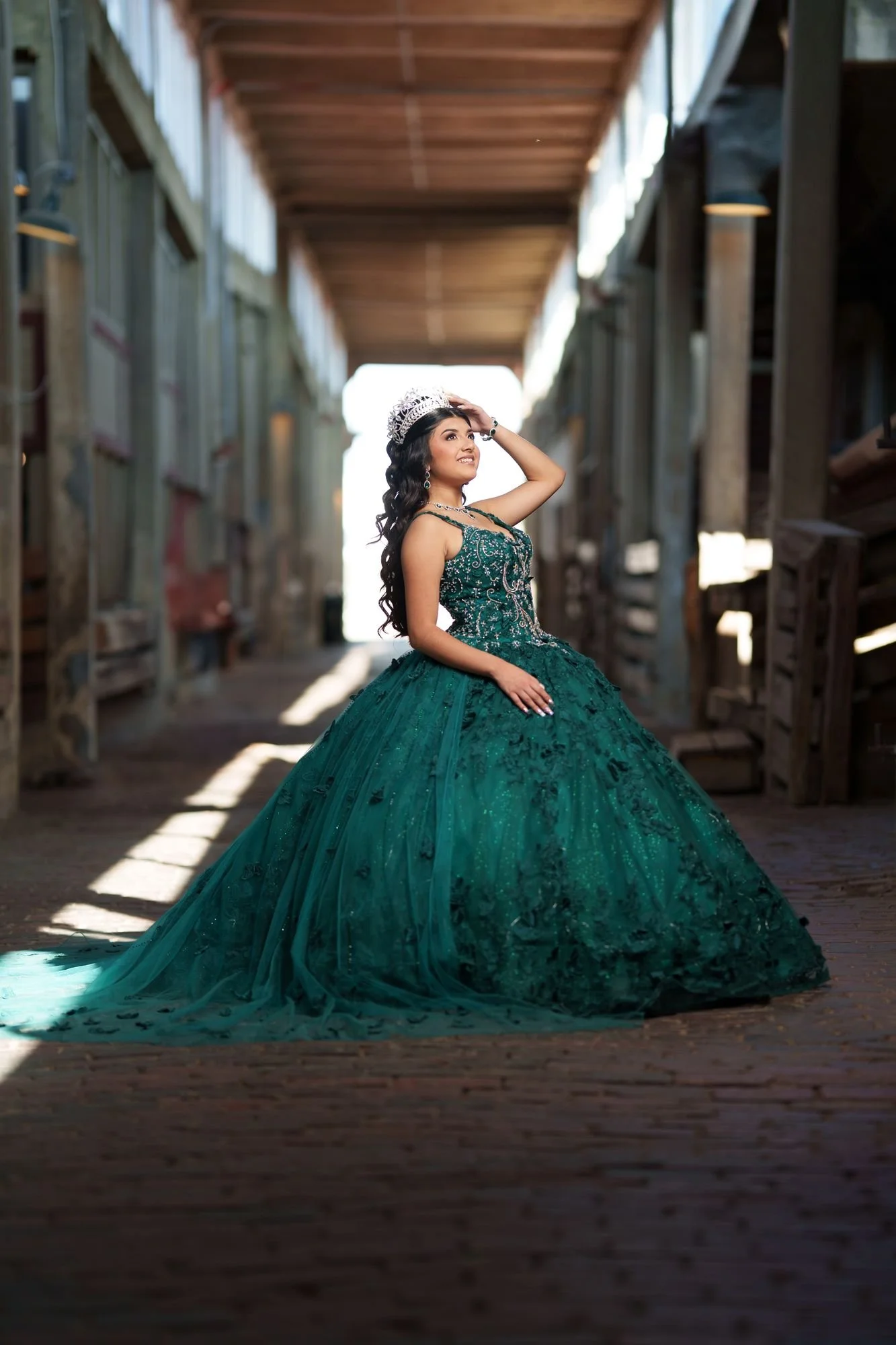 Historic architecture frame of Nevaeh in emerald gown at Fort Worth Stockyards