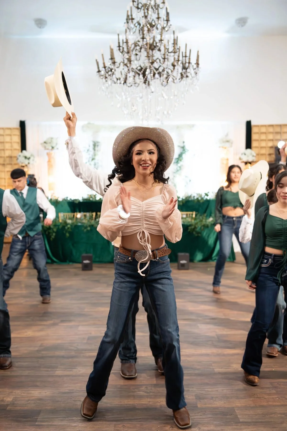 Charro quinceañera tossing her hat on the dance floor at a Fort Worth venue