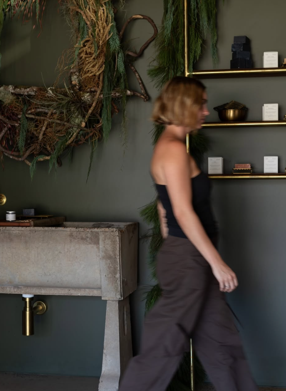 Rhi O'Hanlon, Byron Bay naturopath, walking through the Flore Naturopathy dispensary