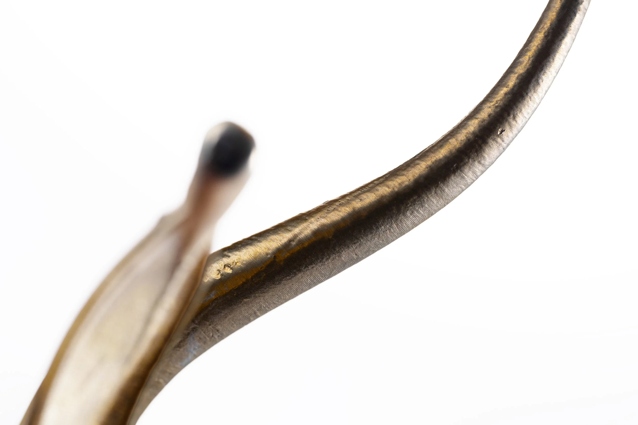 Close-up of a soldering iron tip with a white background.