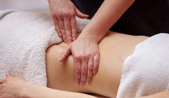 A person receiving a massage on their back from a massage therapist.