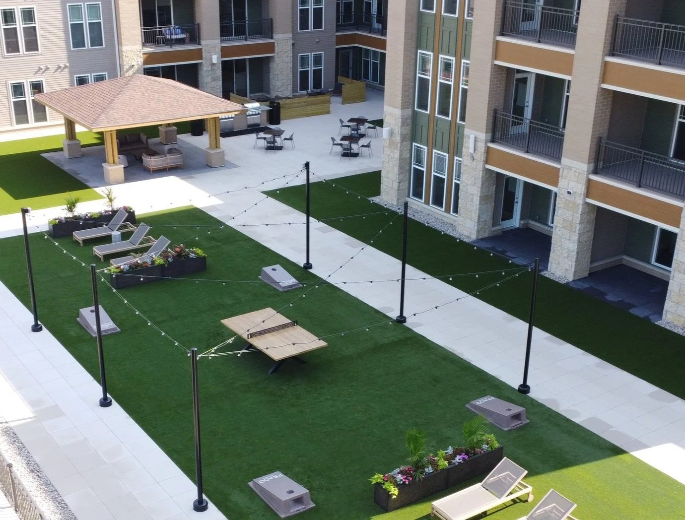 Maintained commercial patio with trimmed shrubs and seasonal color in Menomonee Falls, WI