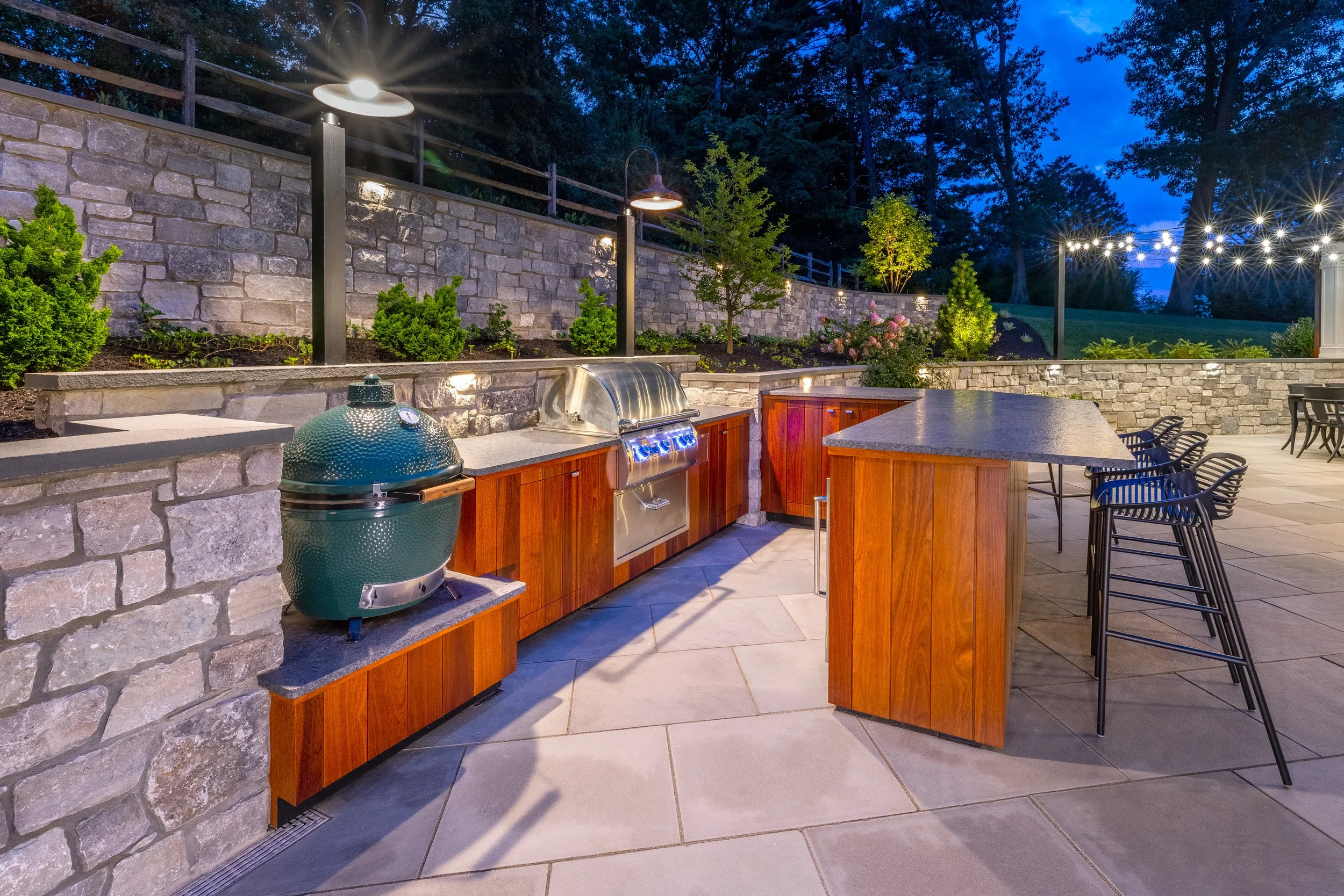 Natural stone wall behind an outdoor kitchen.