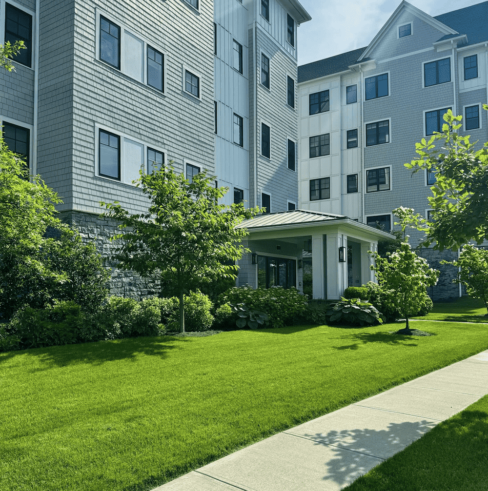 The exterior of an apartment building with healthy landscaping in Westchester County, NY