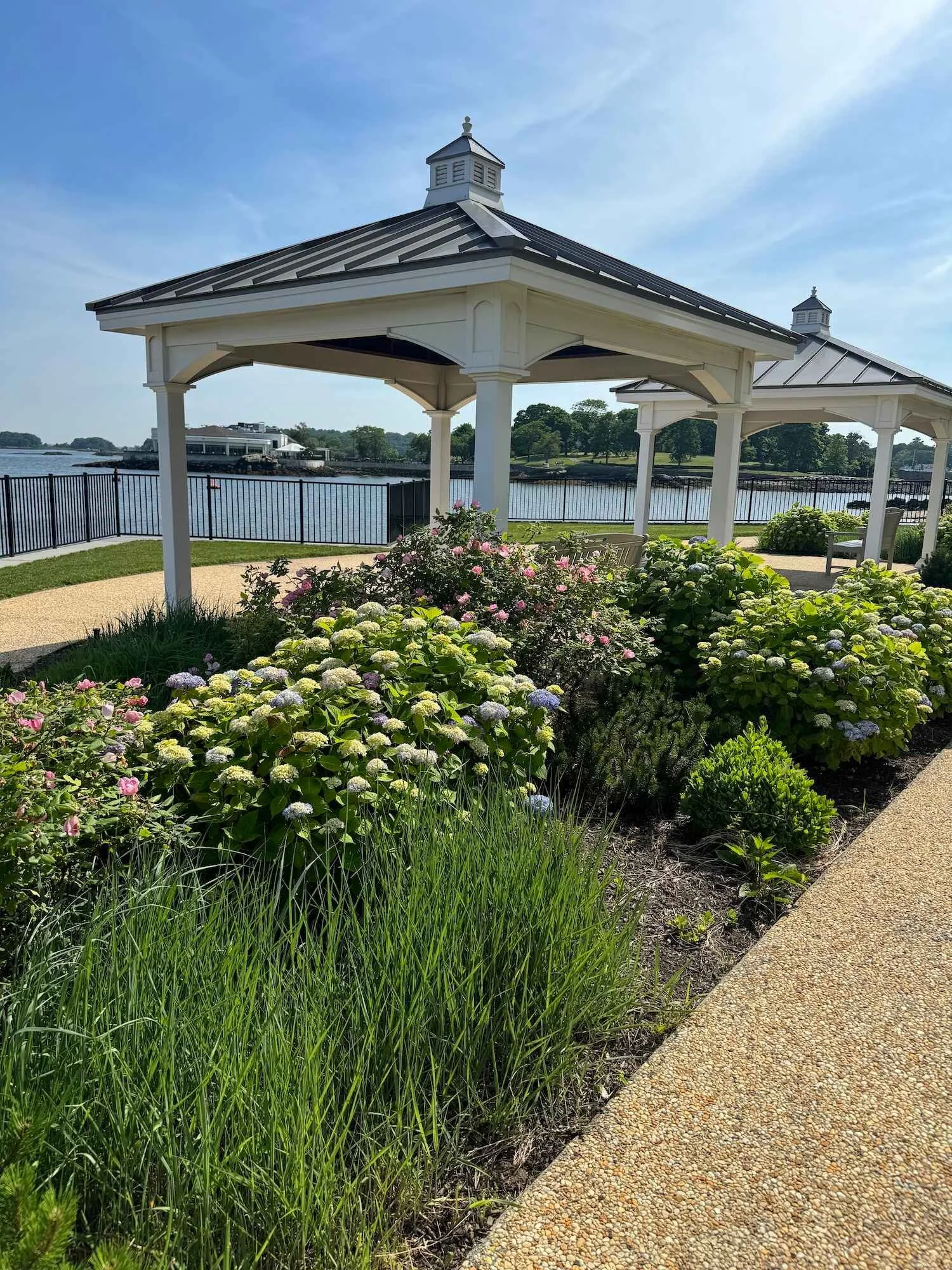 A commercial outdoor space with wooden pavilions and lush plantings in Westchester County, NY