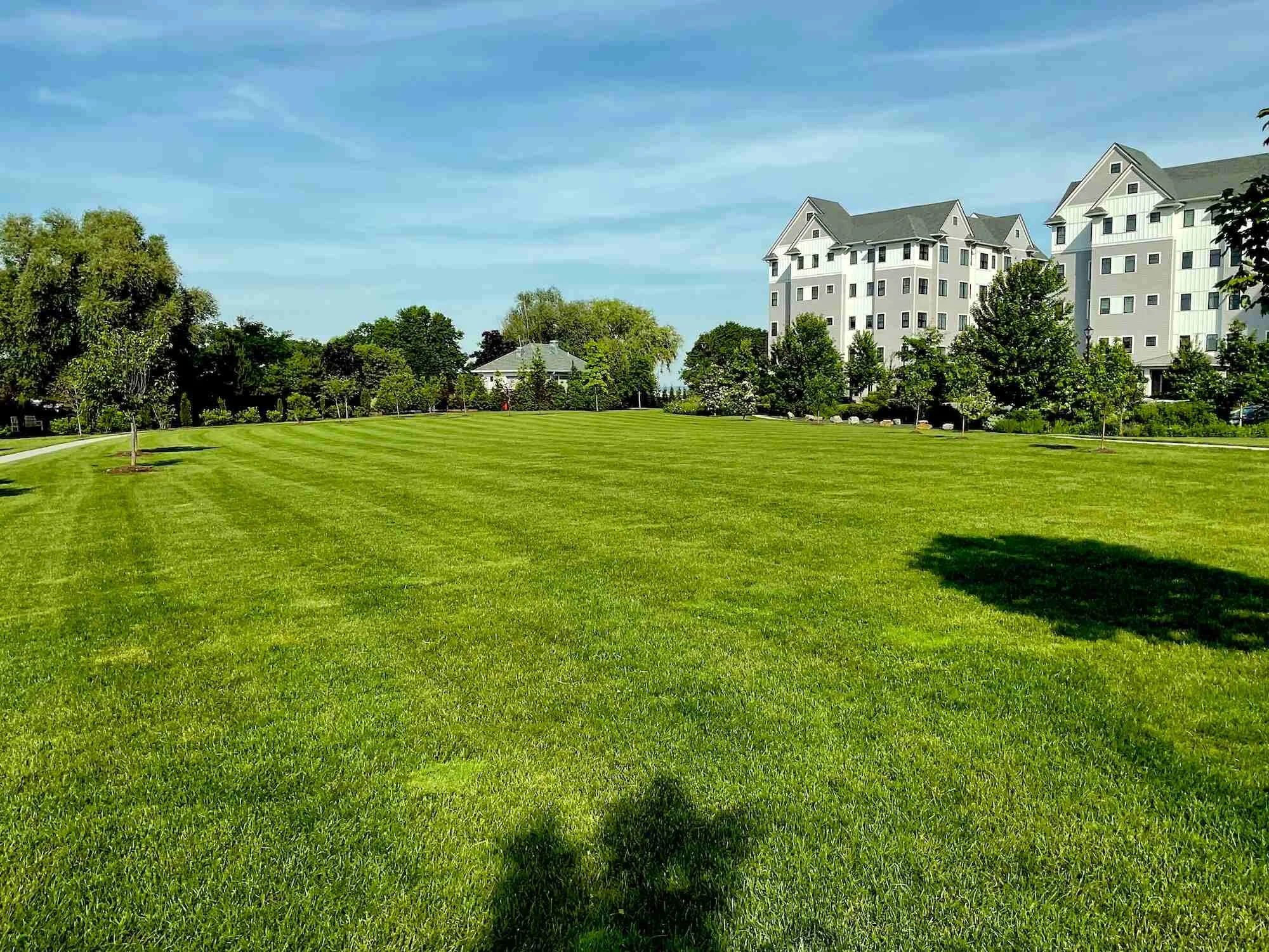 The entrance to an apartment complex with vibrant flowers and beautiful landscaping in  Westchester County, NY