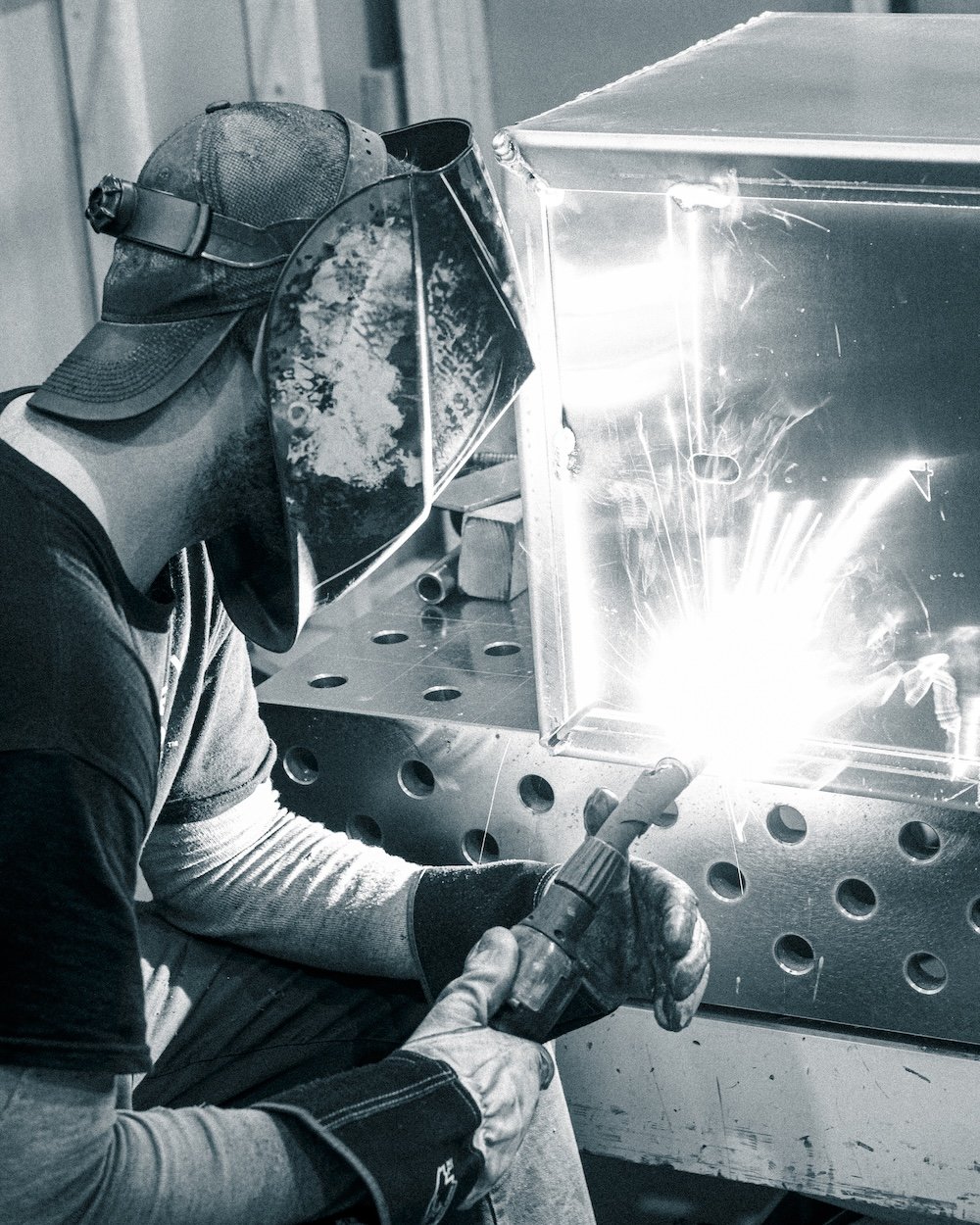 Welder working on custom commercial planter for Pure Modern