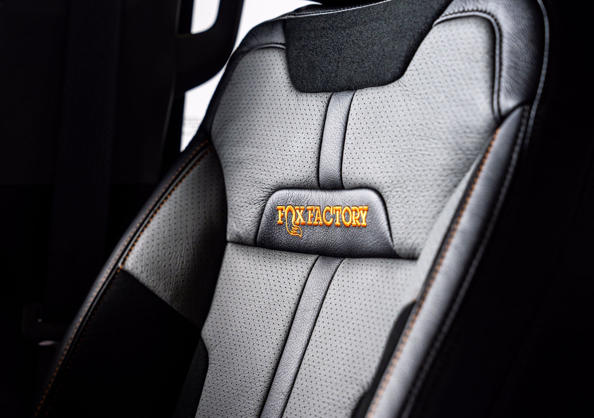 Custom Orange Stitched Two-Tone Leather Seats with Alcantara Suede Inserts and FOX Factory Embroidery