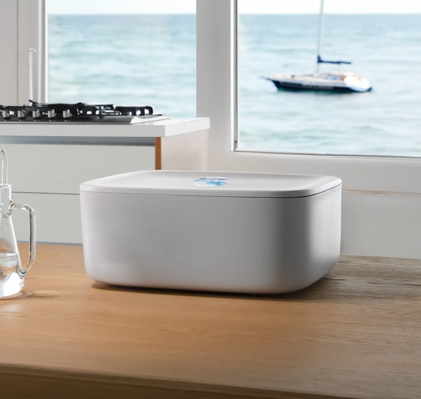 White UV sanitizer box on kitchen counter with ocean view
