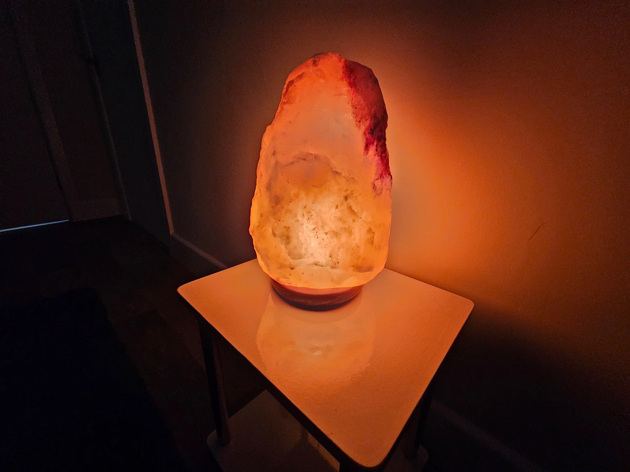 Warm salt lamp lighting inside the E & T Massage Therapies treatment room.
