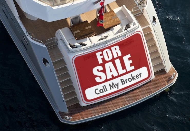 Luxury yacht with 'For Sale - Call My Broker' sign on the back, docked at sea.