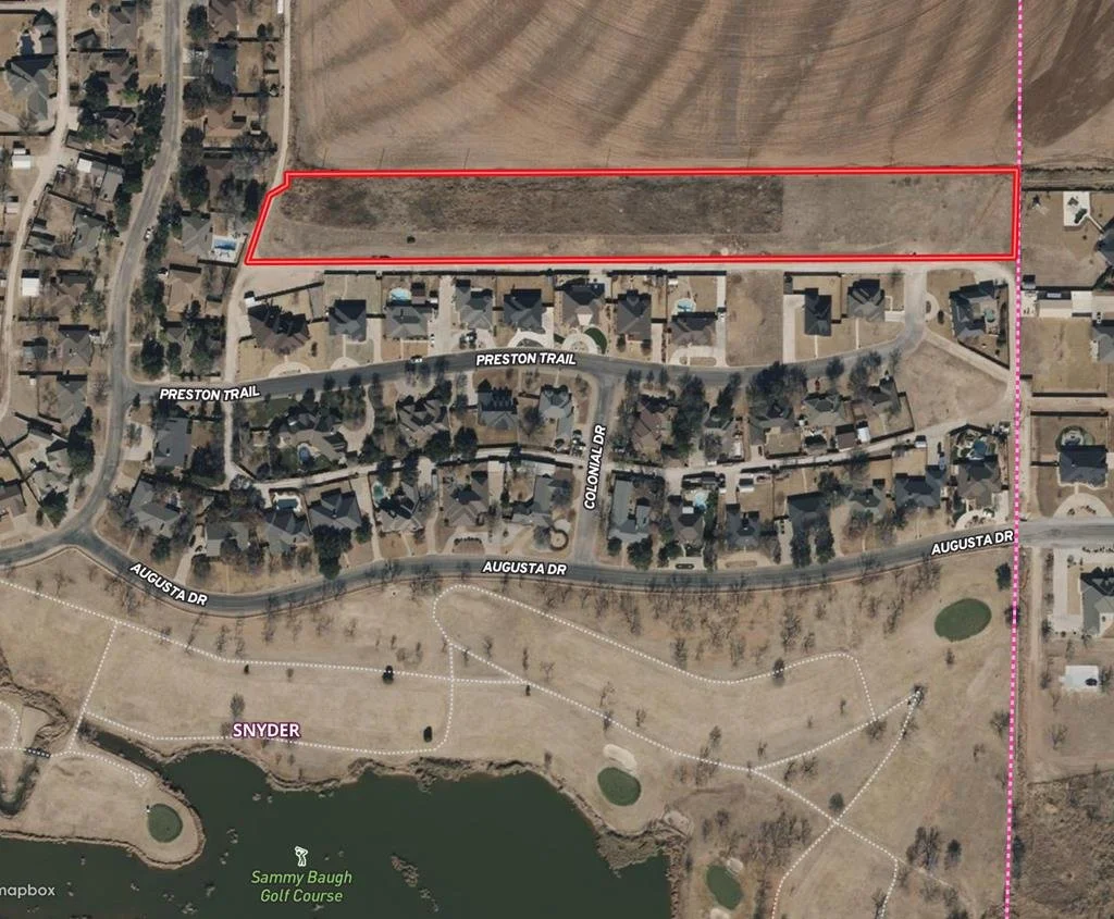 A satellite image showing a residential neighborhood with roads named Preston Trail, Augusta Drive, and Colonial Drive, with a large rectangular vacant lot outlined in red at the top, and a golf course named Sammy Baugh Golf Course and a pond at the bottom.