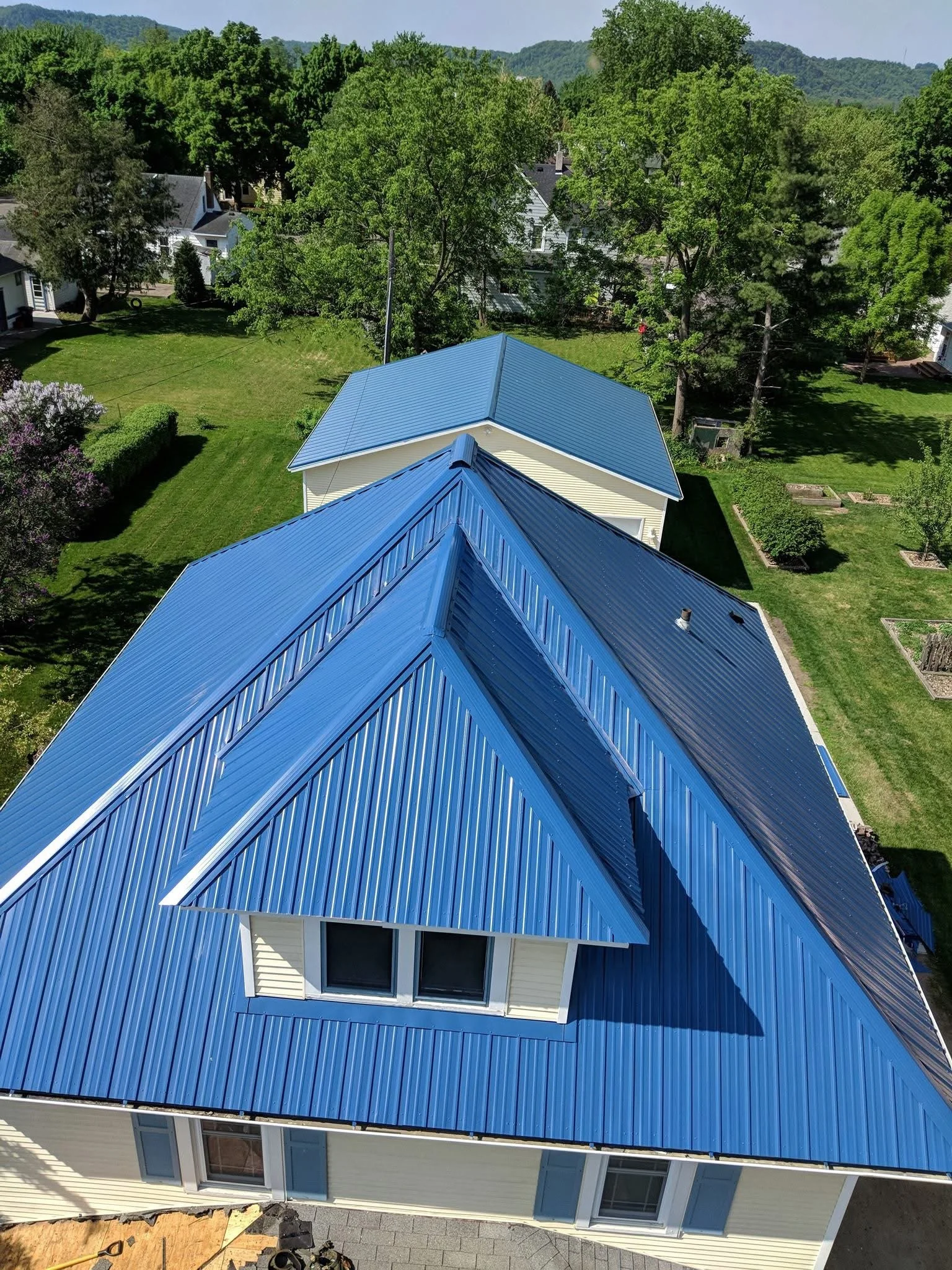 A blue metal roof installed on a residential home in Lake City, MN.